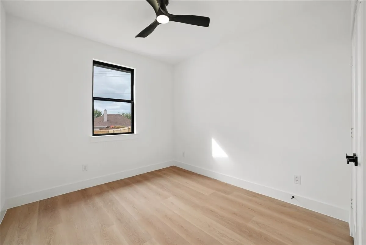 Recessed lighting, wood-finish flooring, and a modern ceiling fan