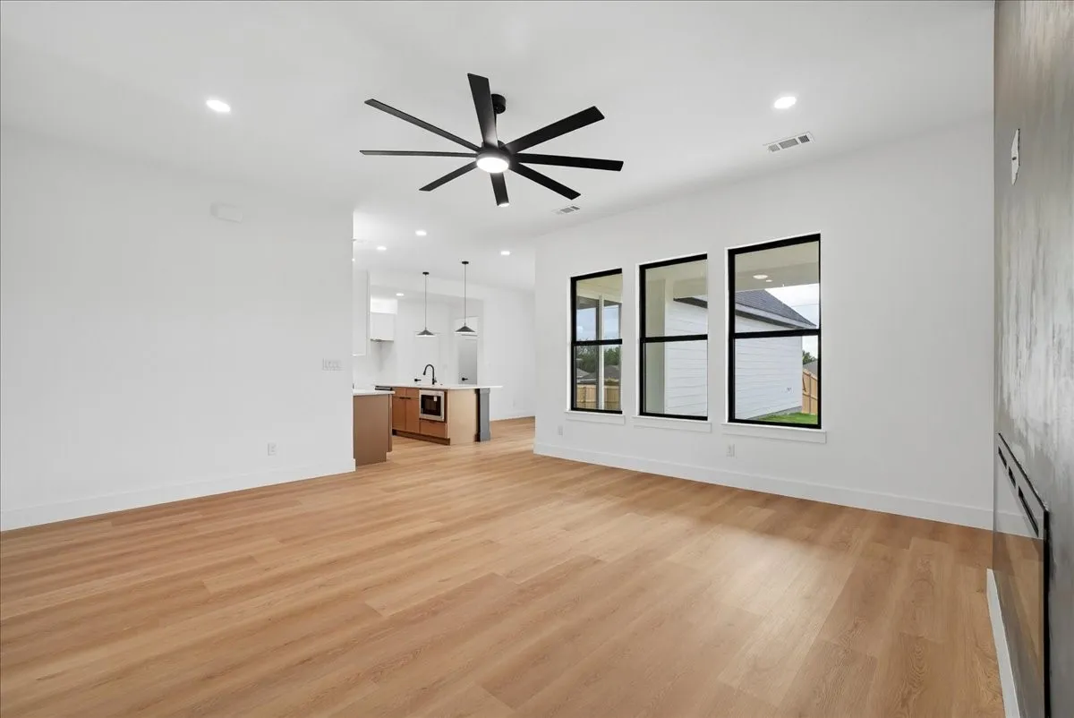Wood-finish flooring, recessed lighting, and a modern ceiling fan