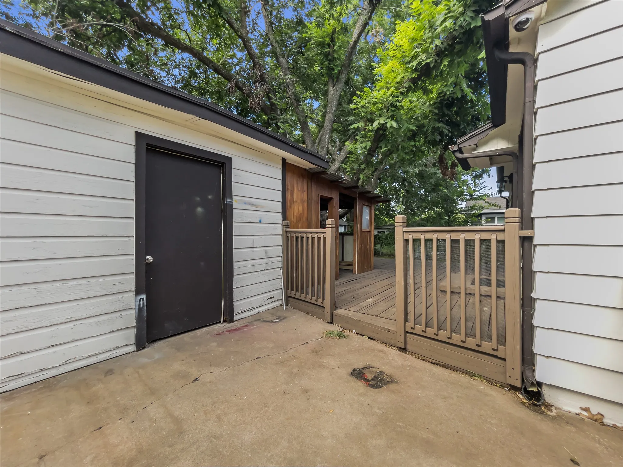 View of deck and storage building from driveway
