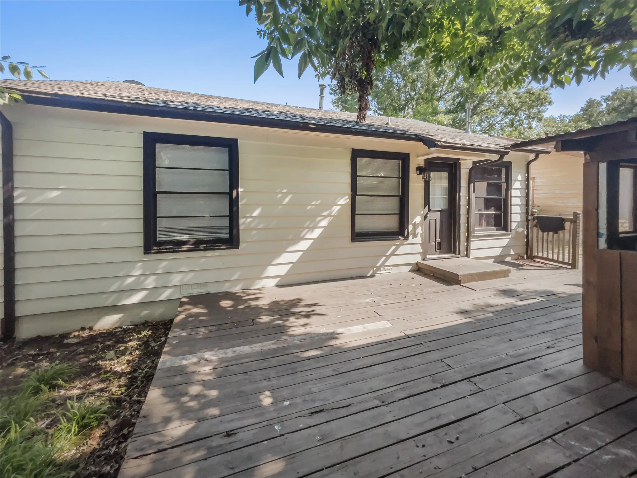 Expansive wooden deck area in backyard