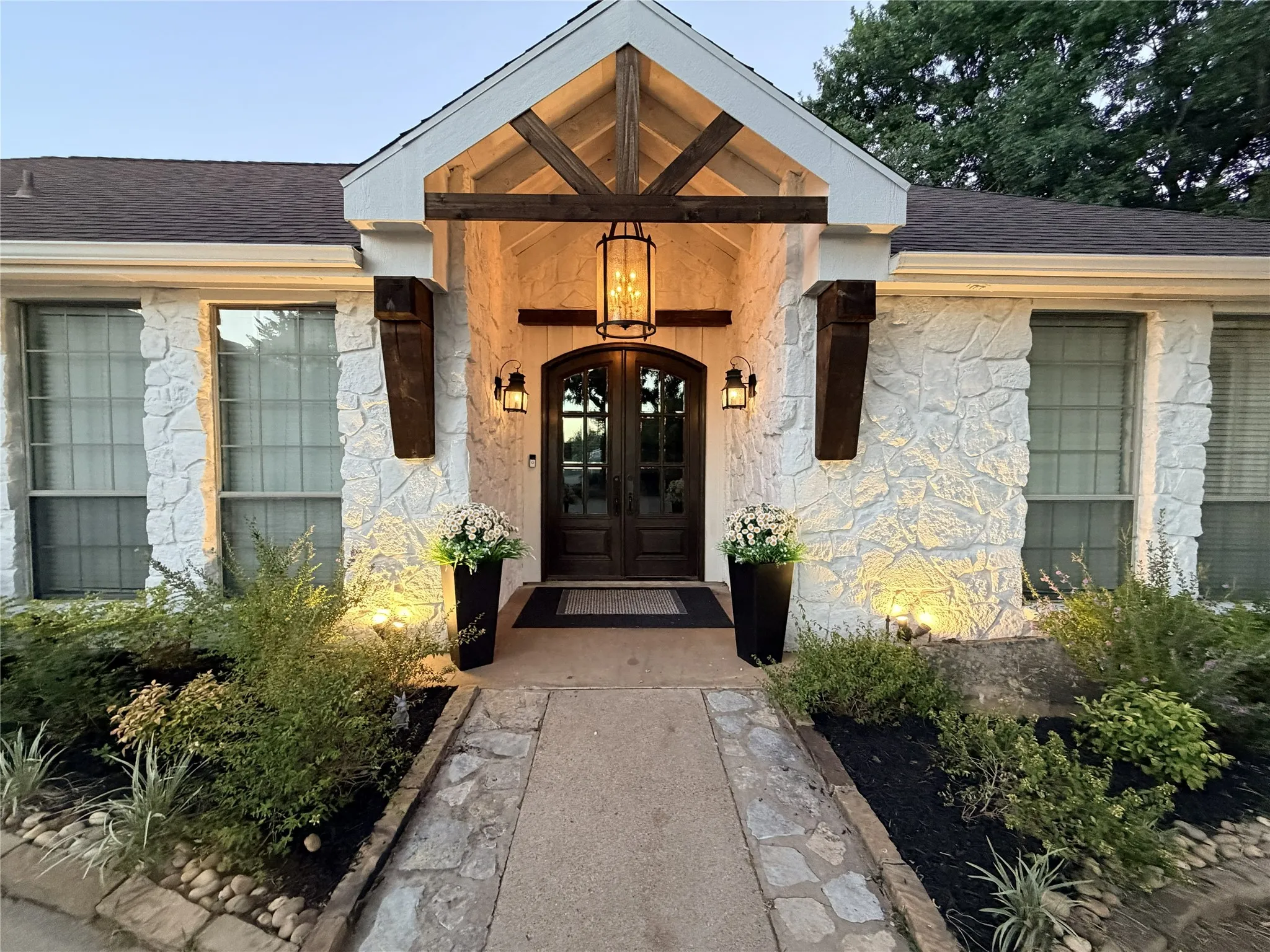Stone exterior featuring a prominent arched double-door entry