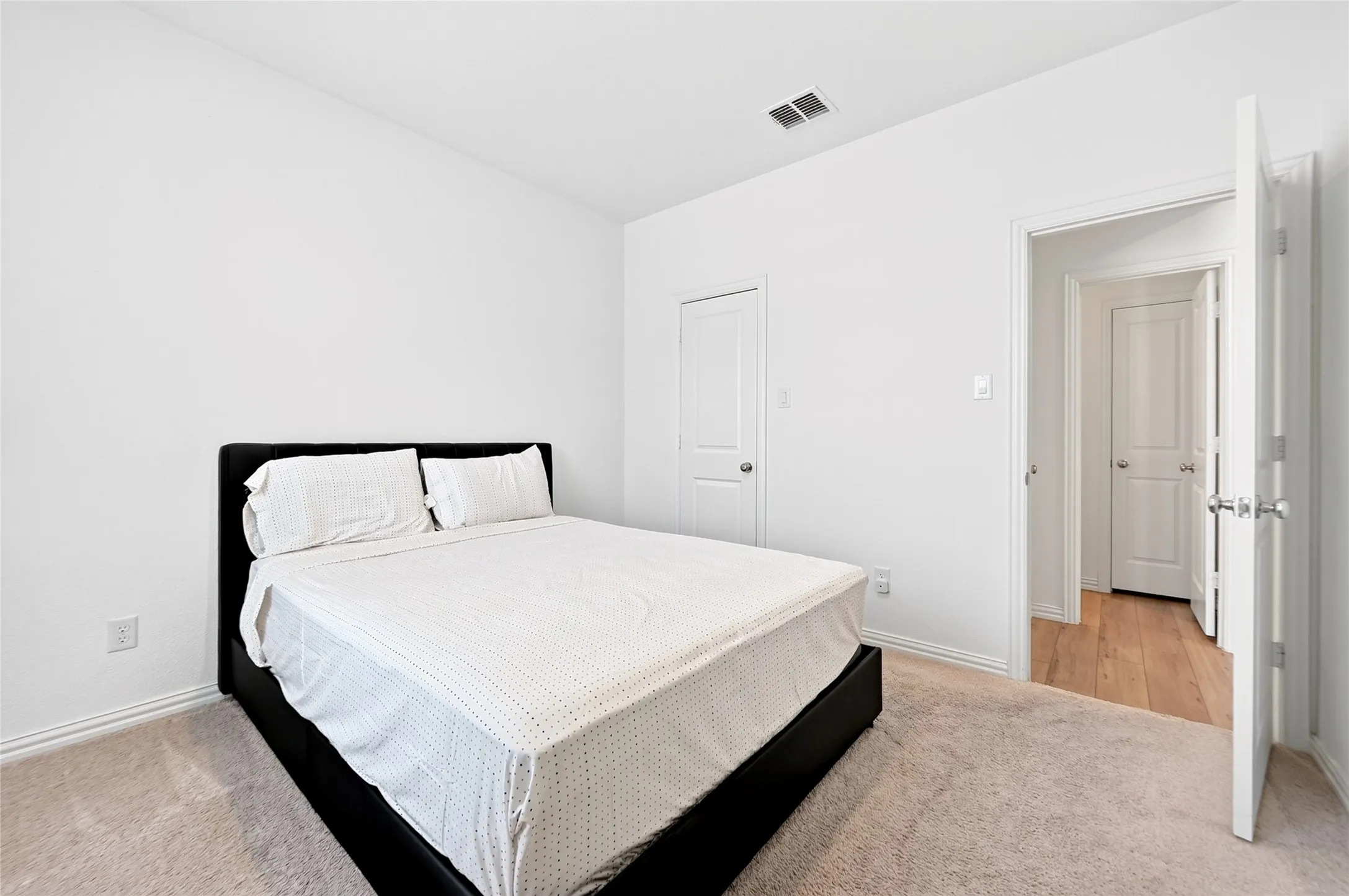 Another view of Bedroom 2 downstairs showing proximity to a second 1st floor full bathroom