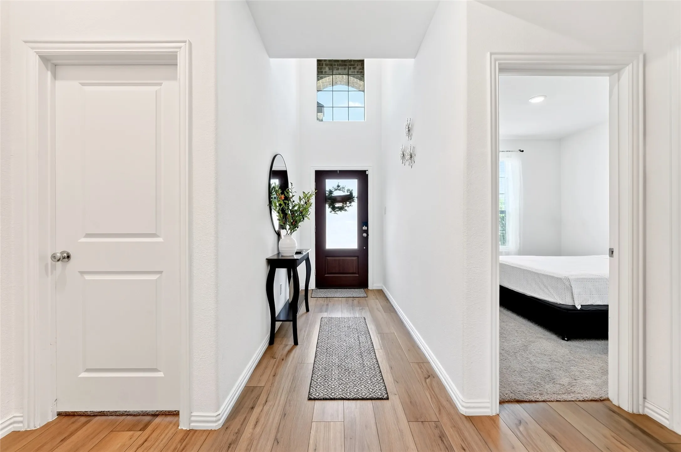 Upon entry you'll find the Primary suite on one side and an additional downstairs bedroom on the other side