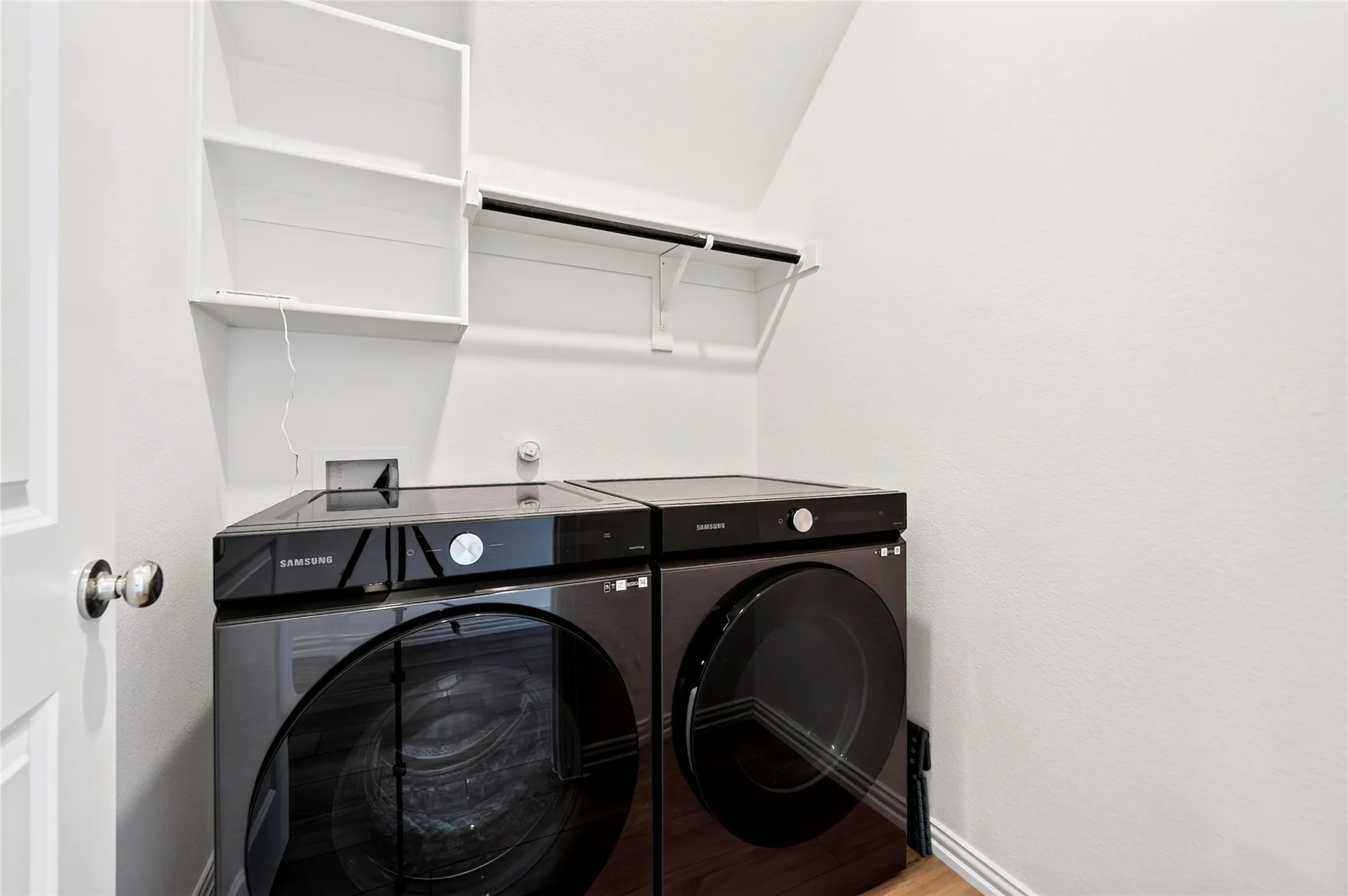 Another view of the utility room showing the washer and dryer that will convey