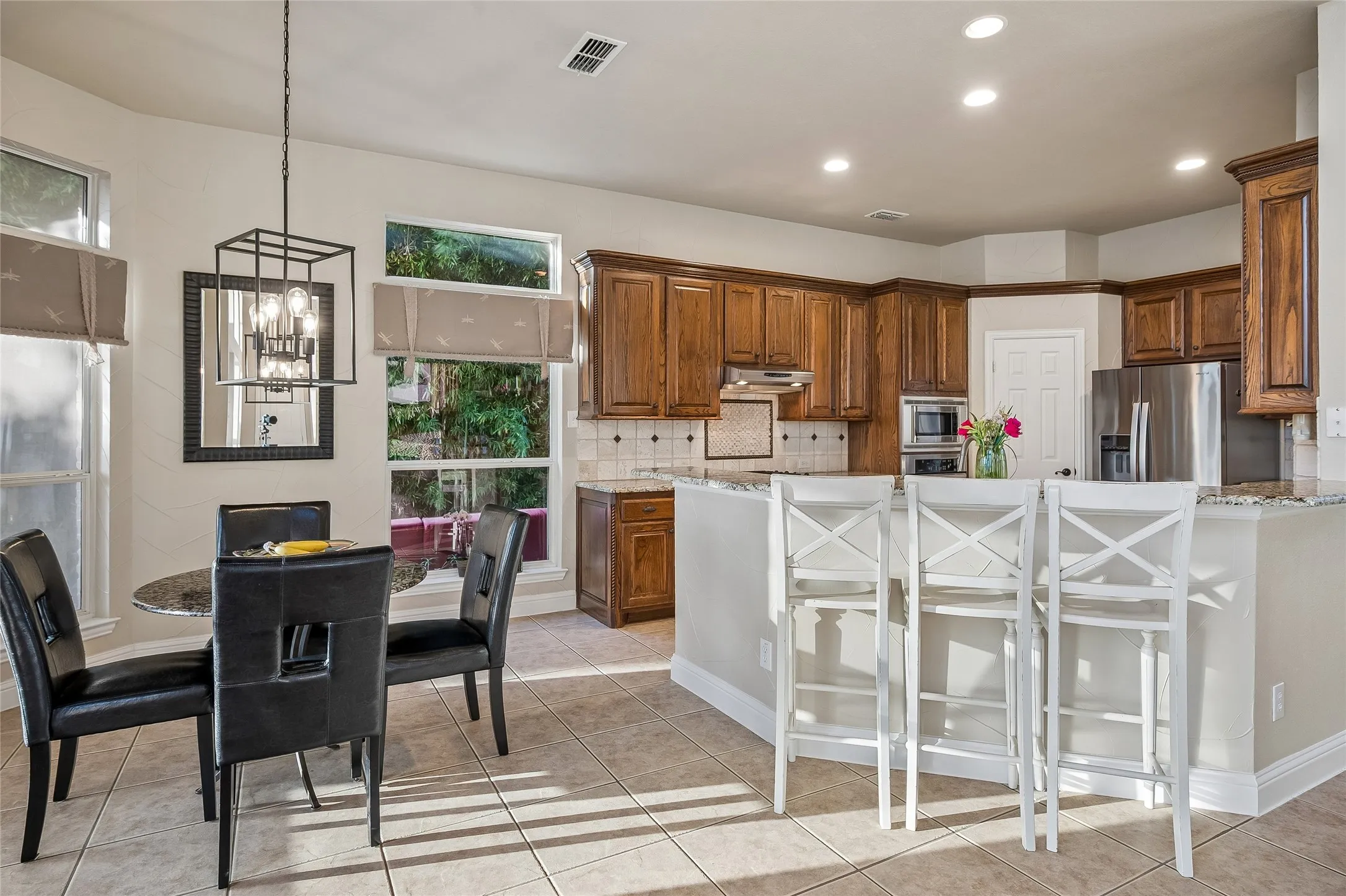Kitchen is  open to family room with  breakfast  dining area and breakfast bar,  Decorative light fixtures