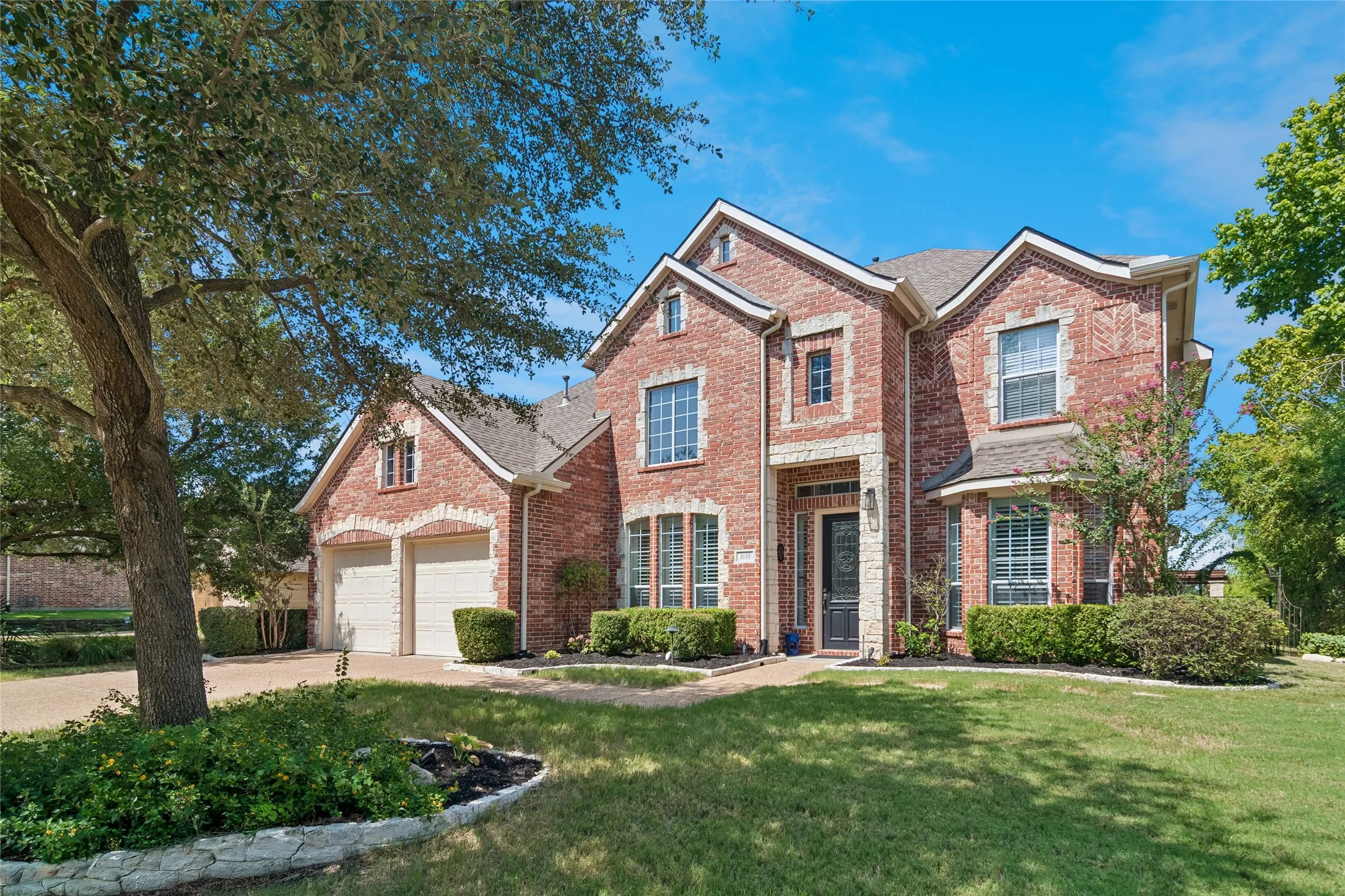 Brick exterior with full landscaping. 3 car tandem garage