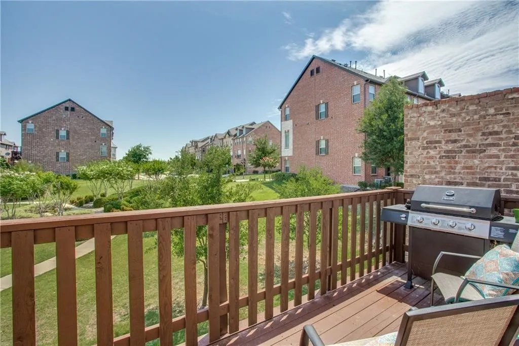 Wooden deck featuring grilling area and a lawn