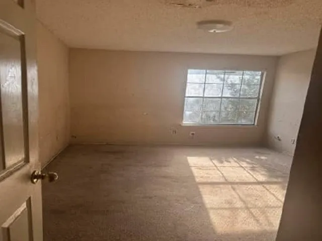 Spacious room flooded with natural light through large fixed windows
