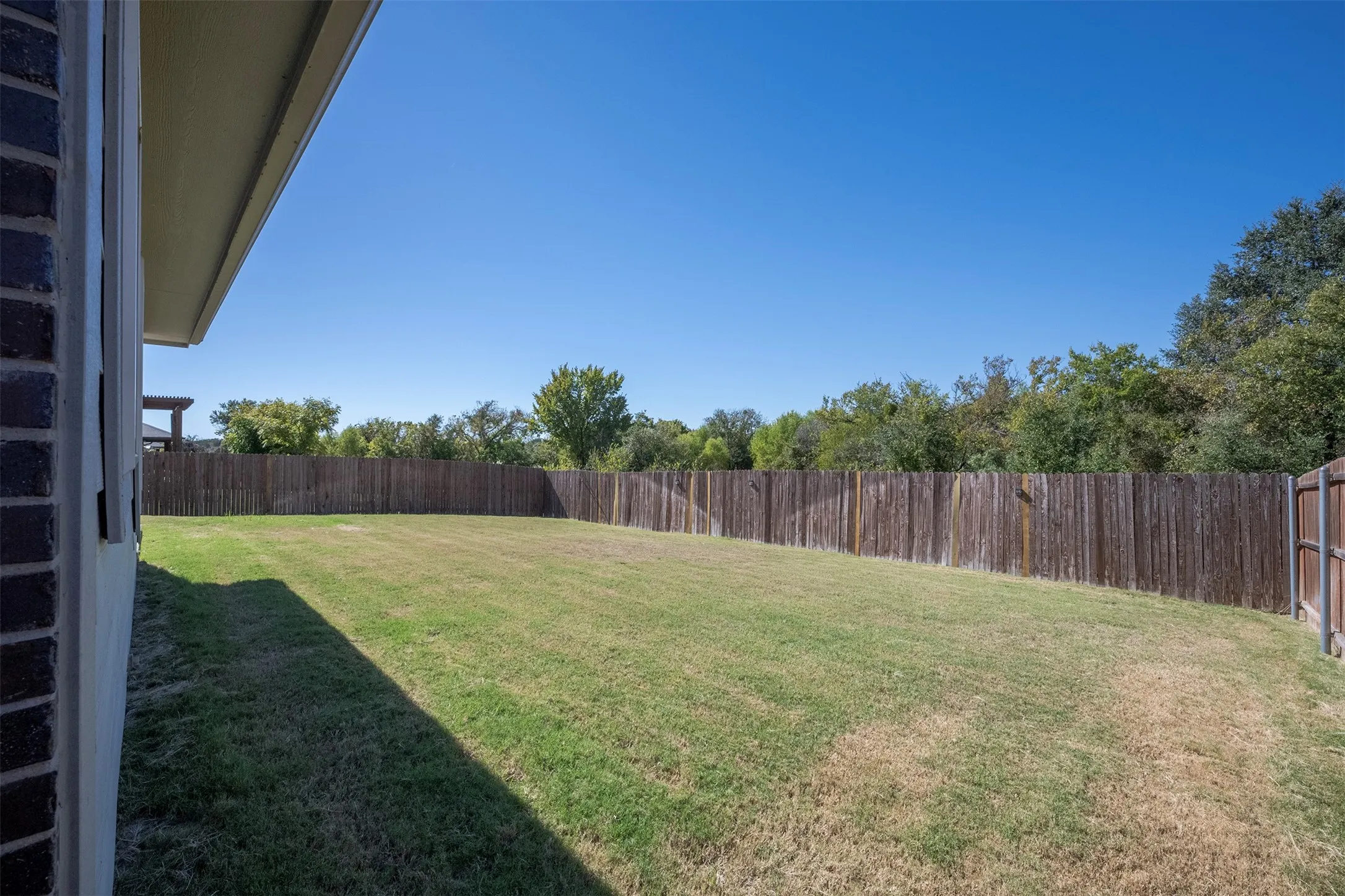 Another look at the oversized back yard - Irrigation system keeps the lawn watered for you.