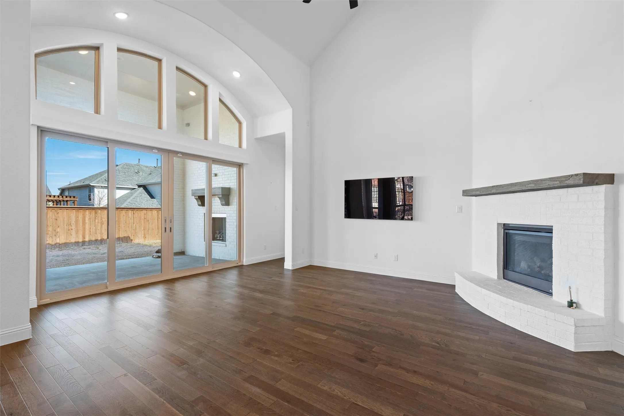 Living room goals! ??? High ceilings, tons of natural light from those arched windows, and a cozy fireplace. Imagine the movie nights here! ???? #LivingRoomDecor #HighCeilings #CozyHome
