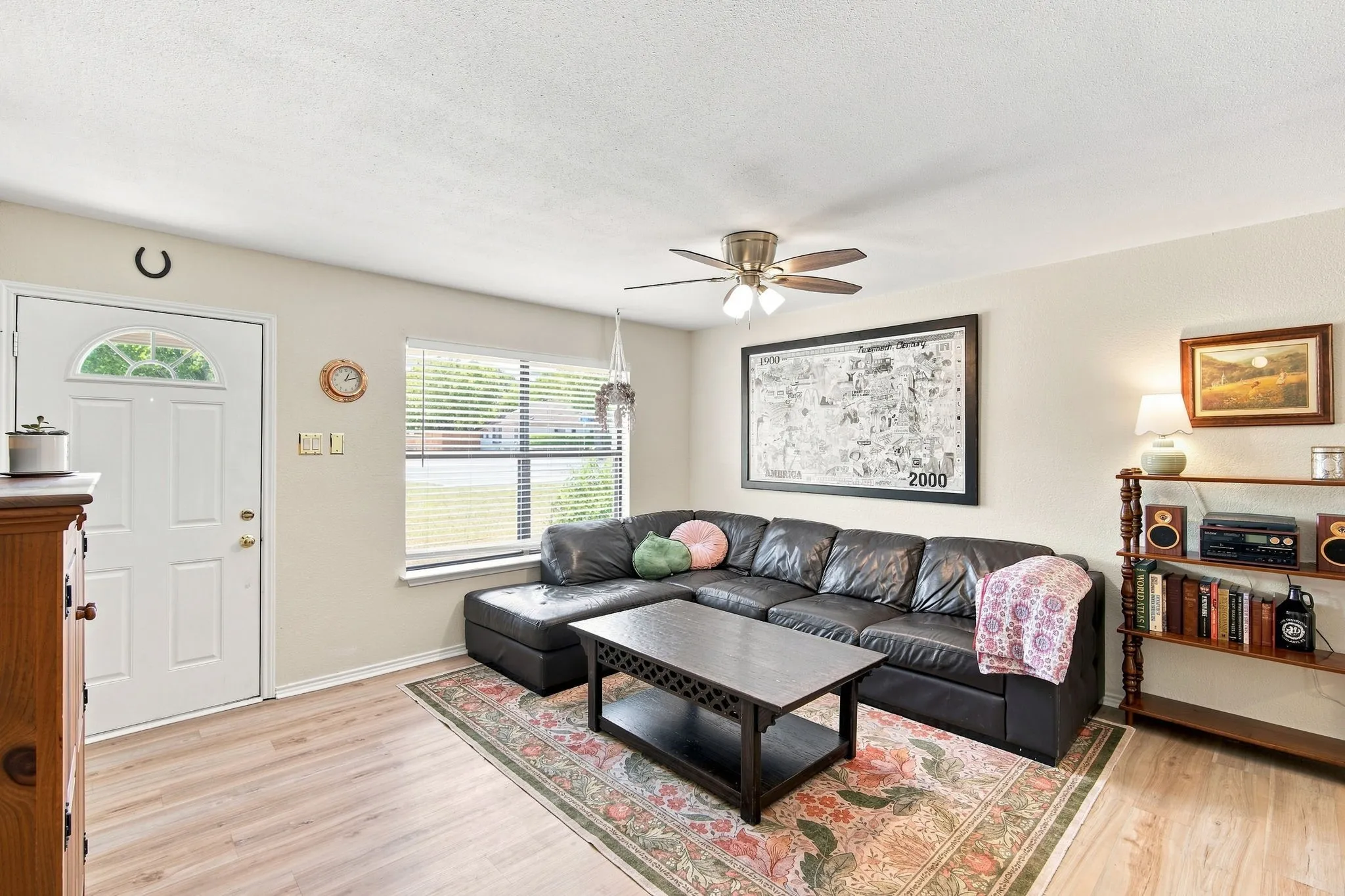 Bright living room with a large window bringing in wonderful natural light, ideal for relaxing or entertaining.