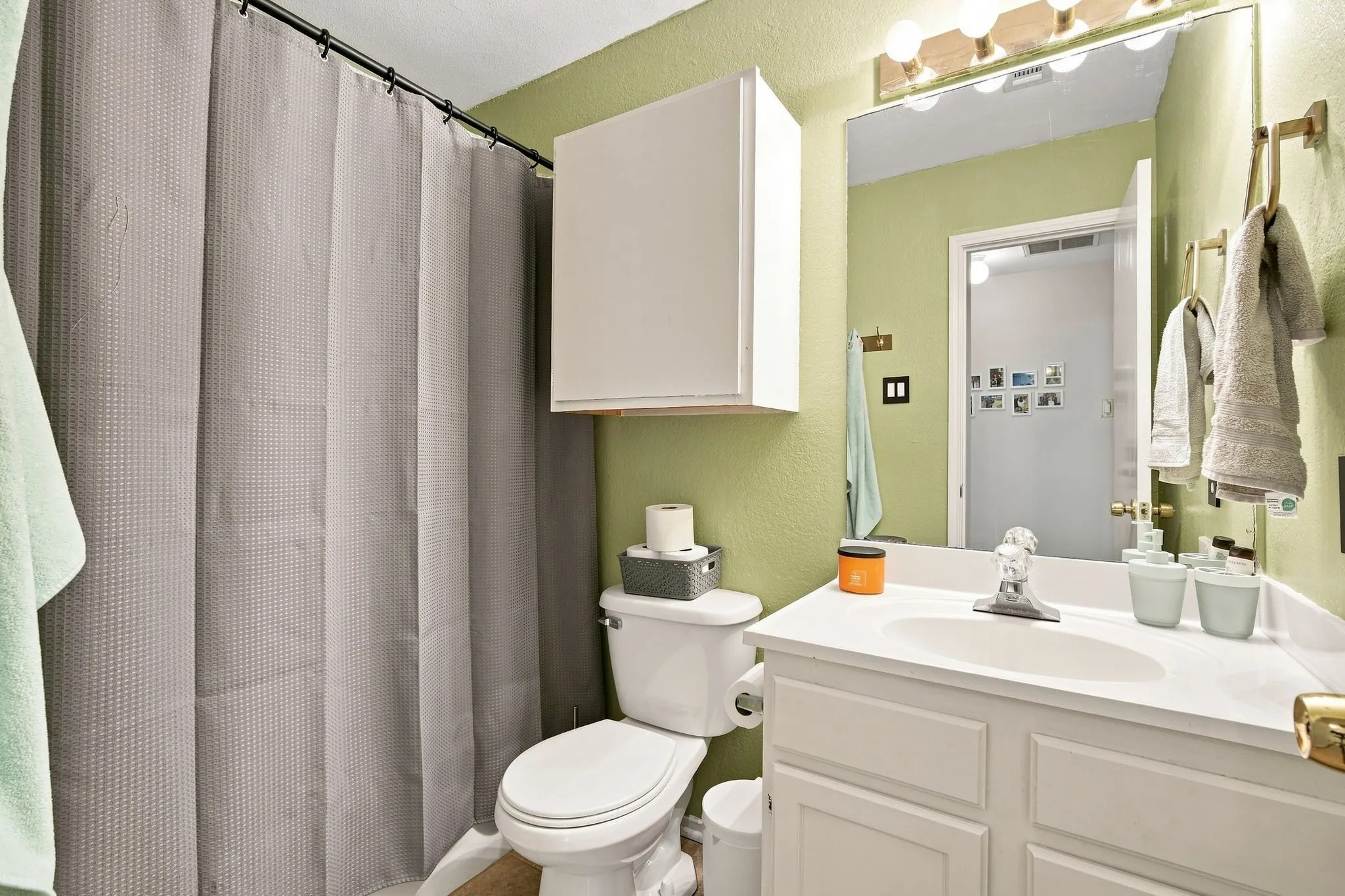  Full bathroom featuring a tub/shower combo and ample cabinet storage.