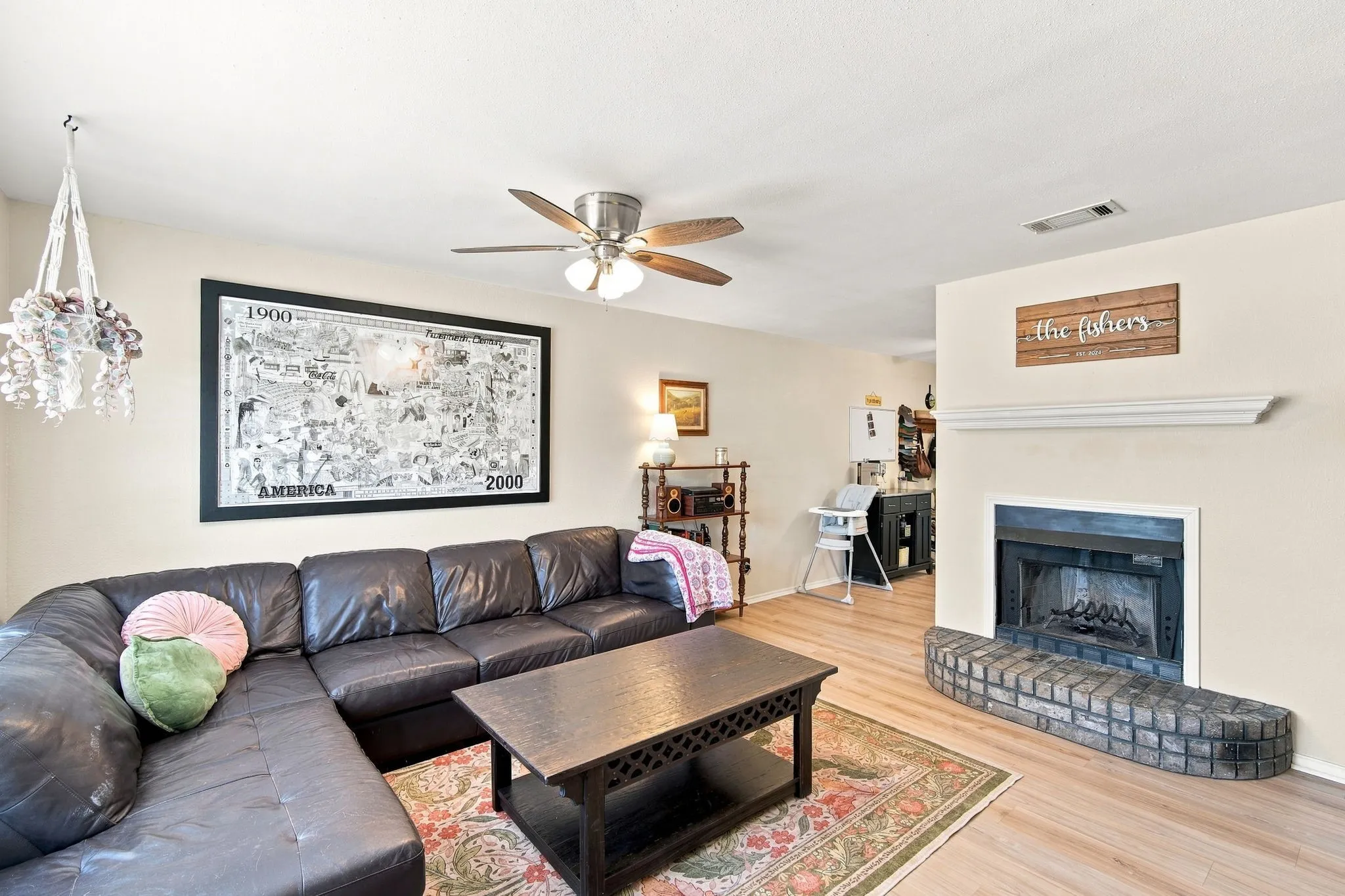 Cozy living room centered around a classic brick fireplace, a warm and welcoming gathering space.