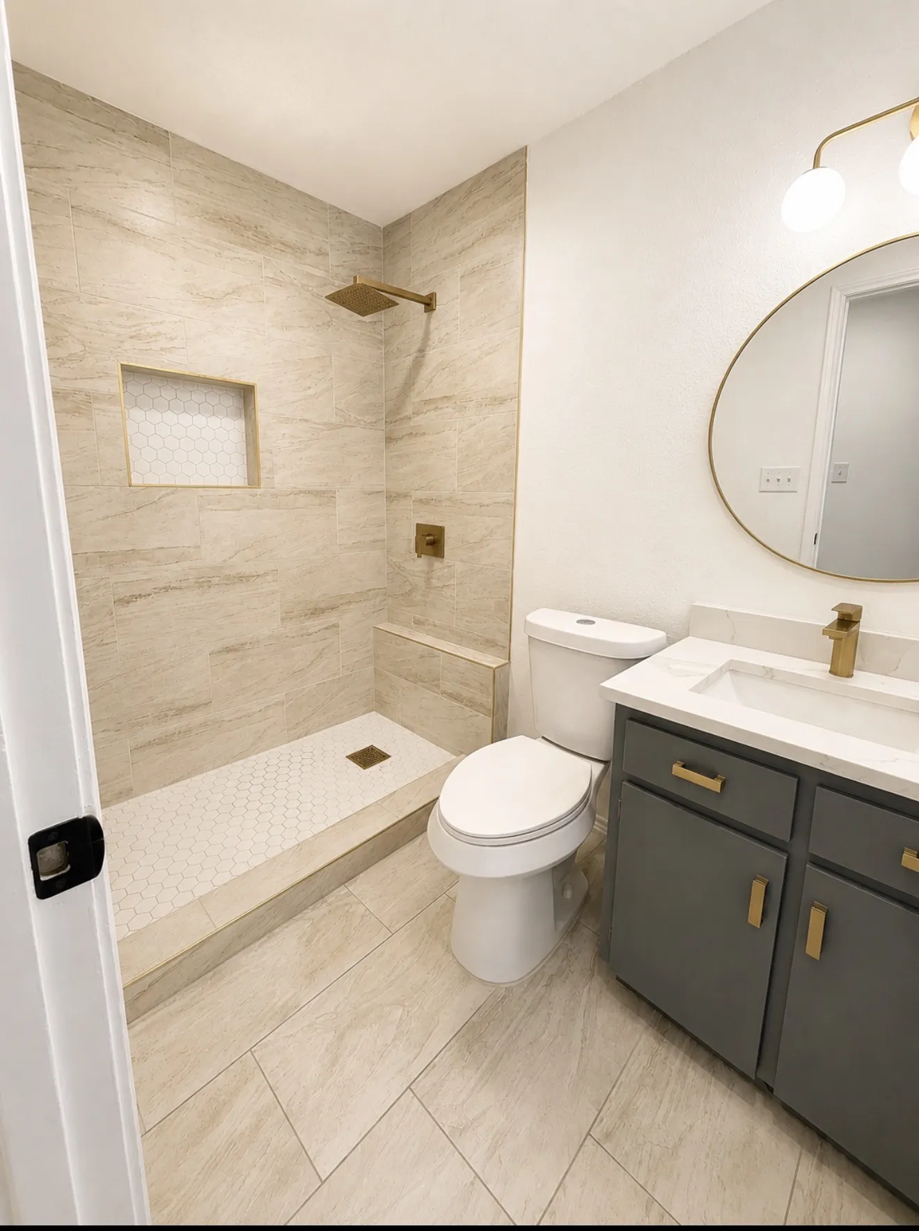 Modern bathroom featuring a walk-in shower with large format tile walls and a hexagonal mosaic floor