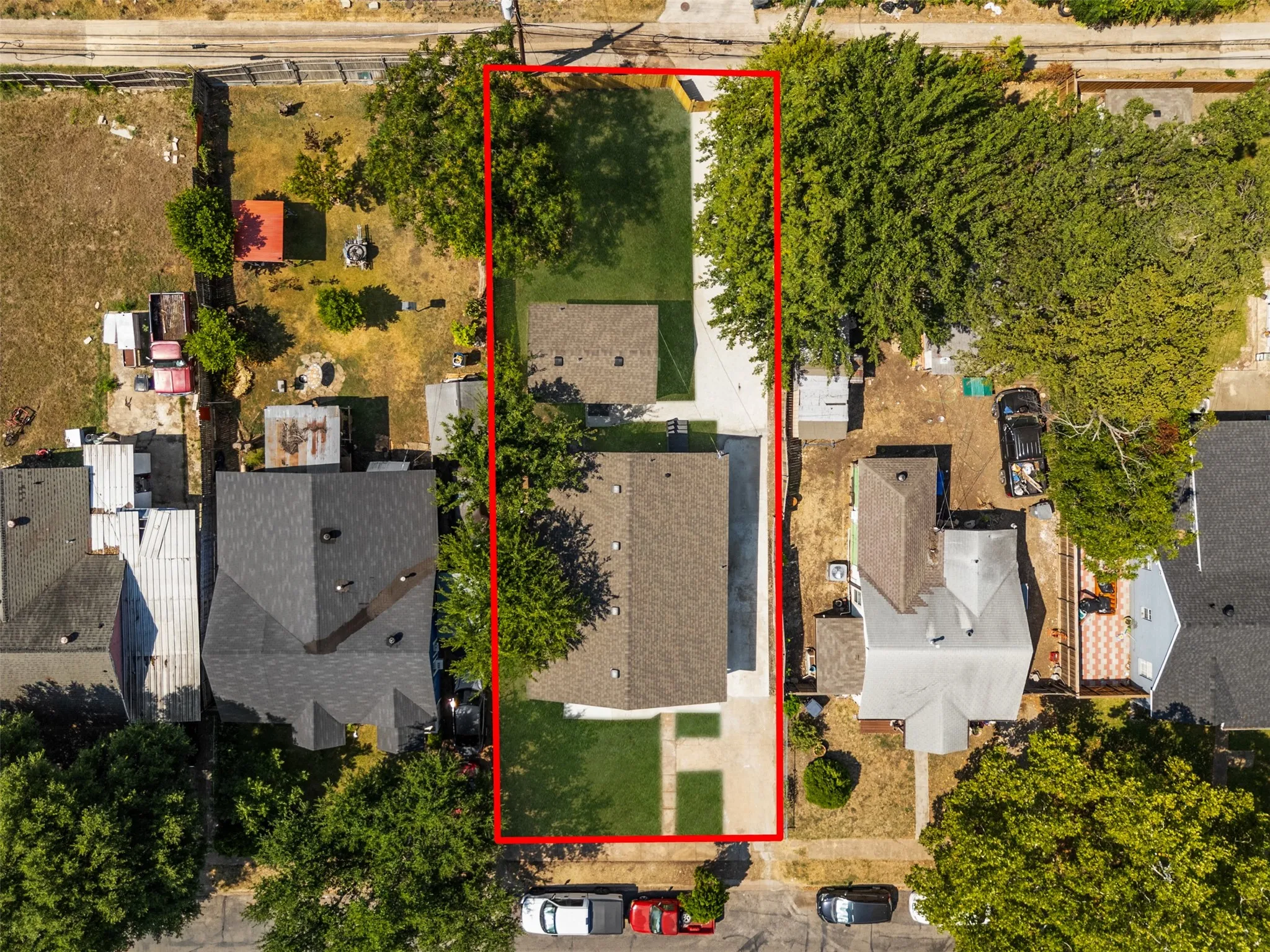 Single-story residence featuring a dark shingle roof and a concrete driveway
