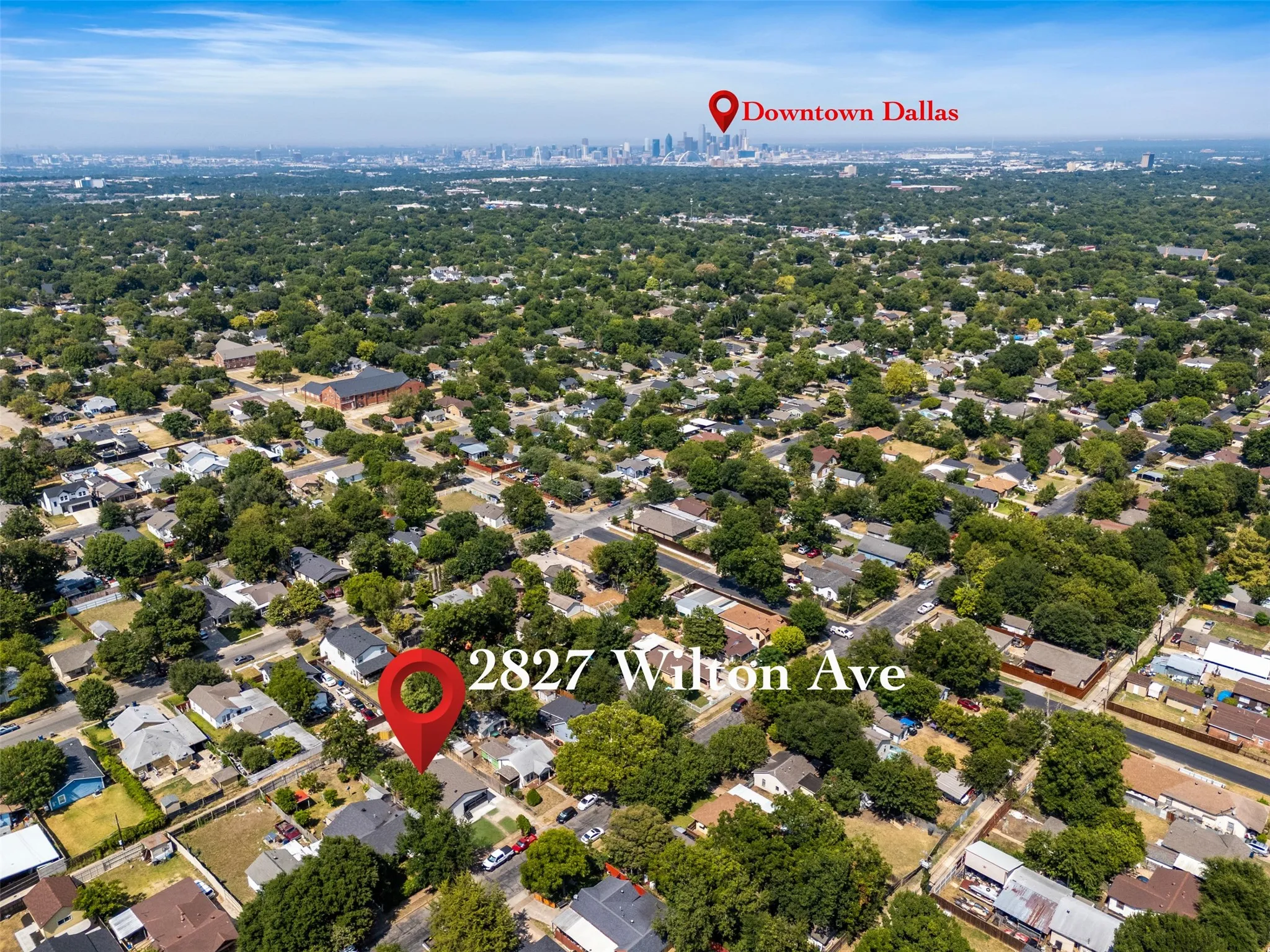 Aerial perspective of a residential neighborhood with a dense tree canopy