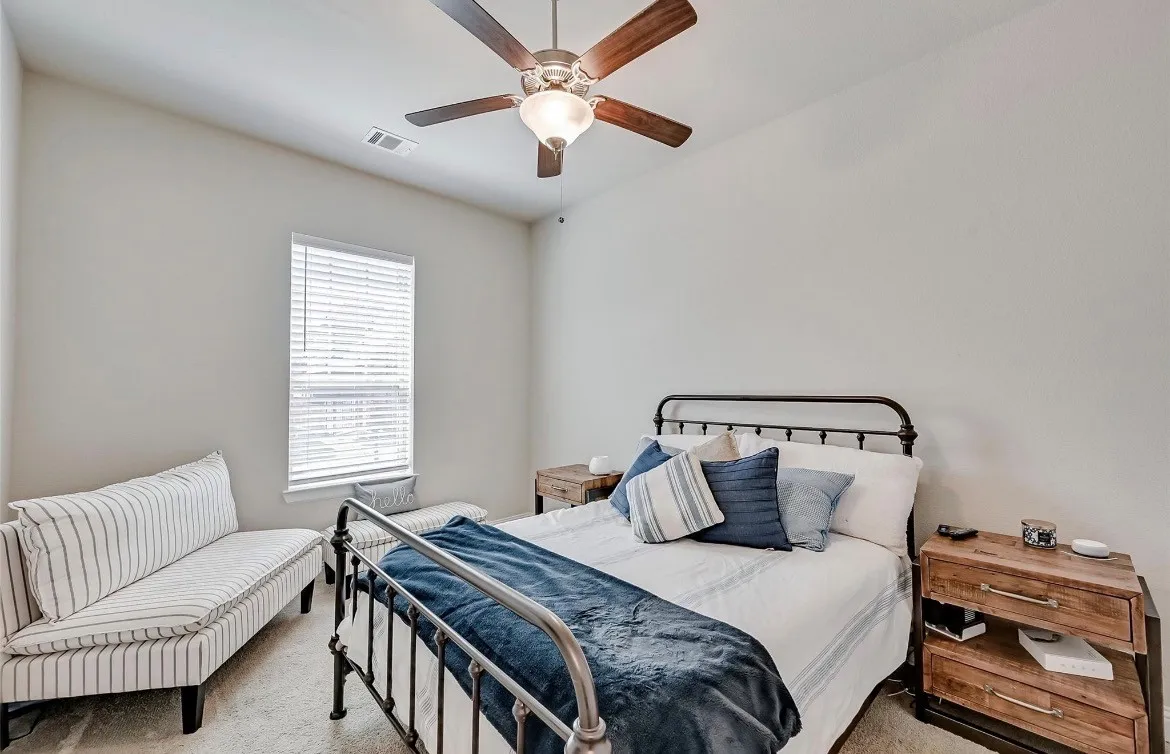 Secondary Bedroom featuring ceiling fan, walk-in closet