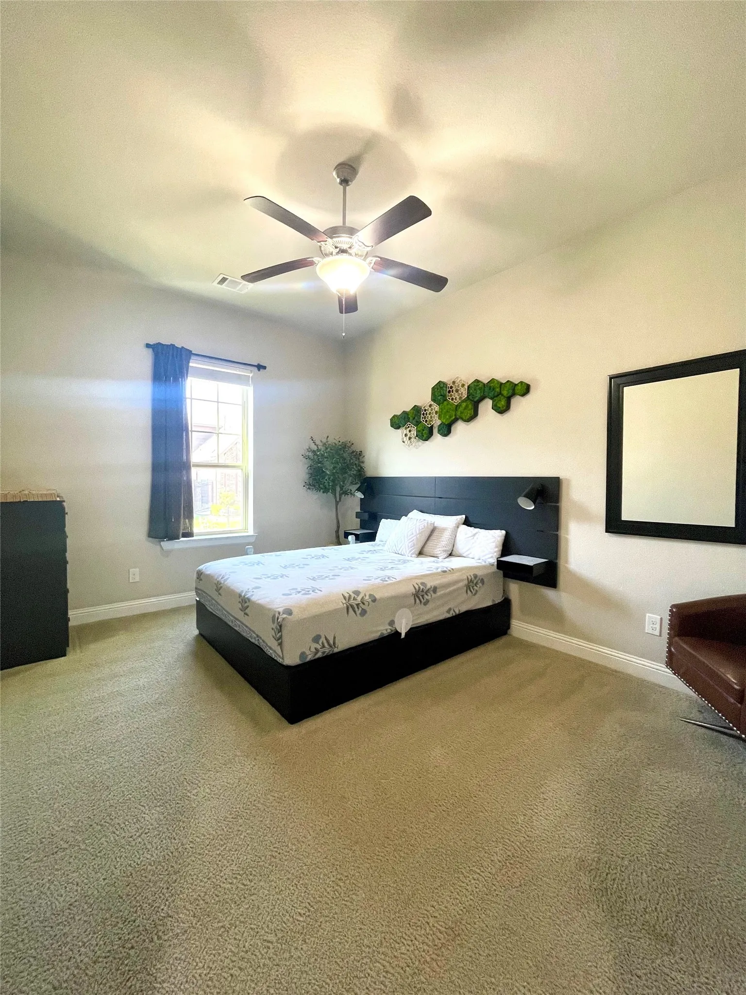 Third bedroom featuring ceiling fan, walk-in closet