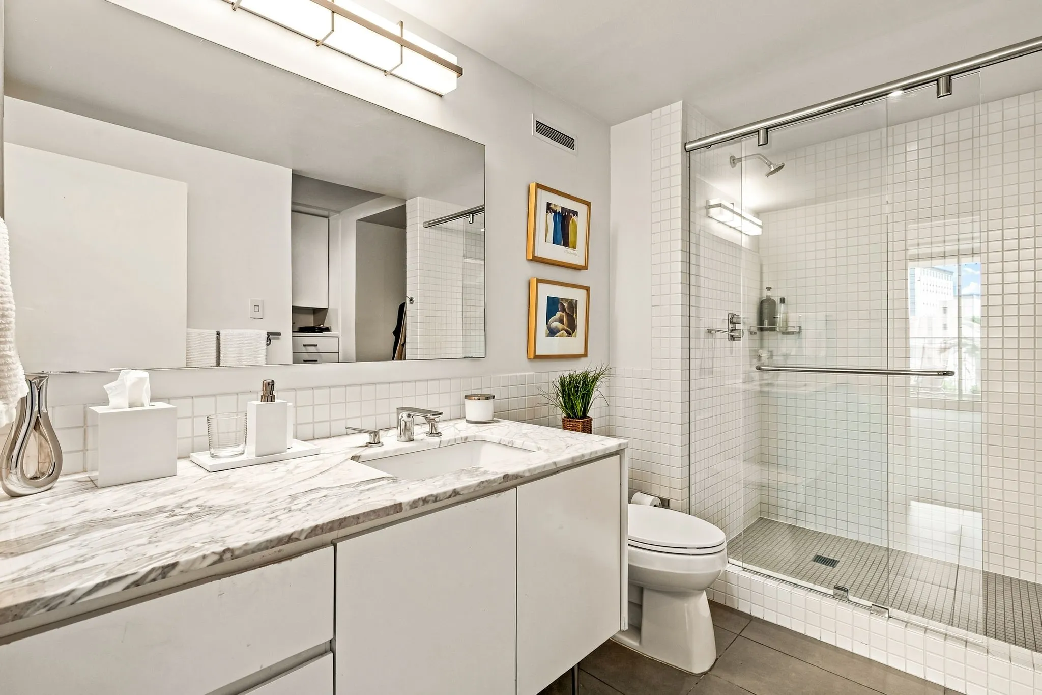 Beautifully appointed marble countertop and a walk-in closet to the right.