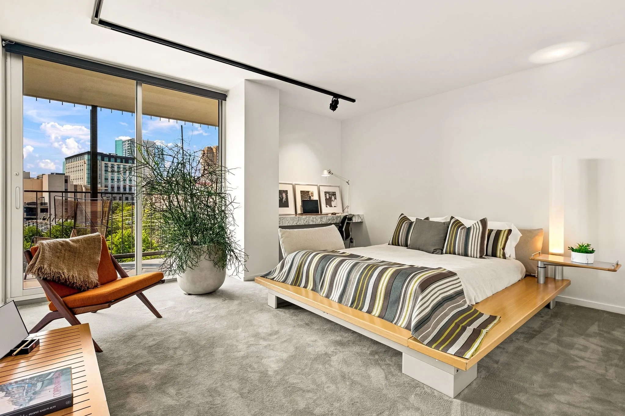 This room doubles as an office with the built-in desk and task lighting above. The closet area is not shown and is to the right.