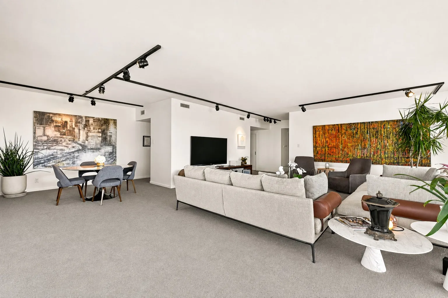 Dining area adjacent to the kitchen, flexible enough to accommodate an expanded dining table or an additional conversation area, while maintaining a seamless connection to the outdoor living space.