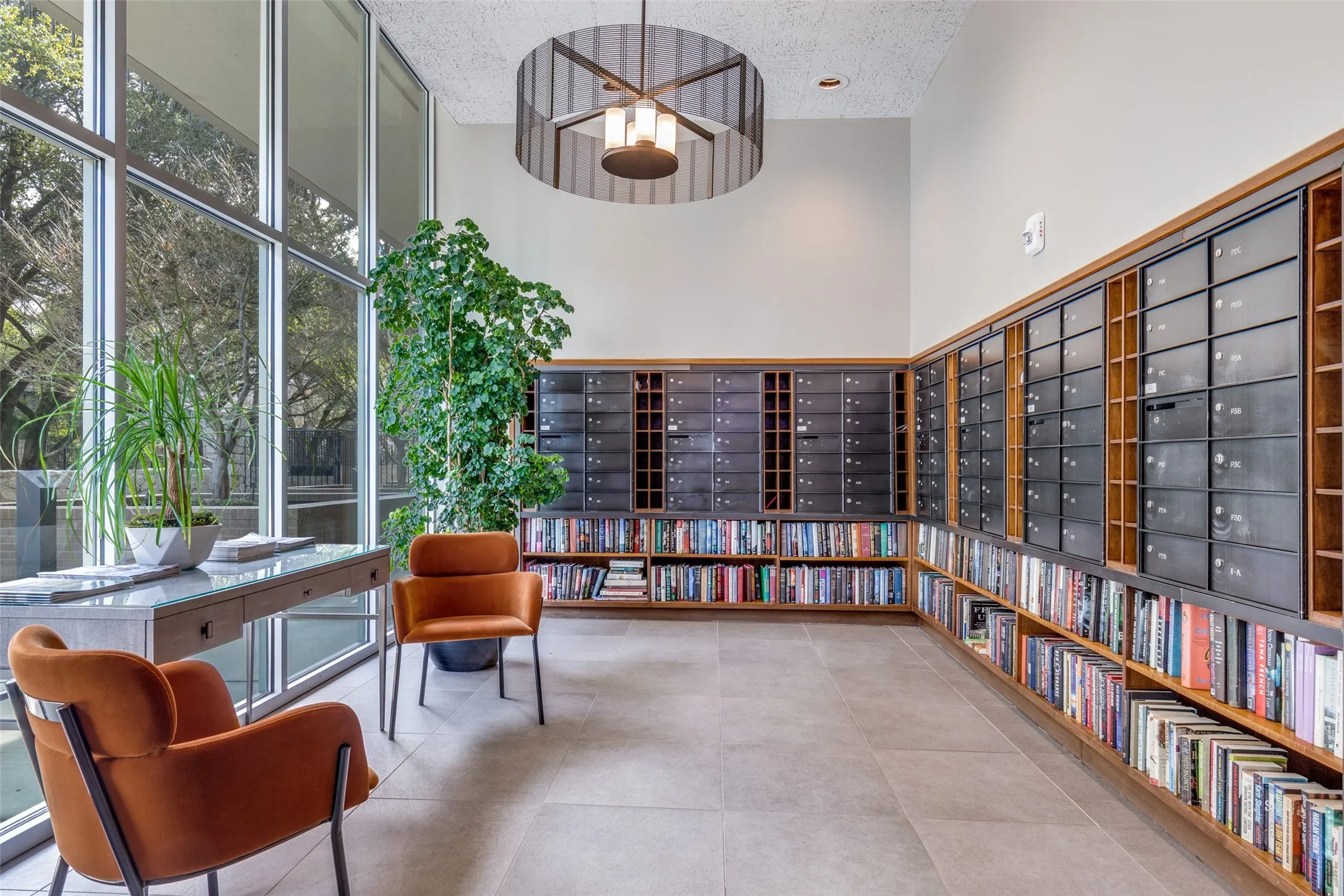 Even the mailroom is thoughtfully reimagined as a library that homeowners can enjoy. Also flooded with natural light from floor-to-ceiling windows.