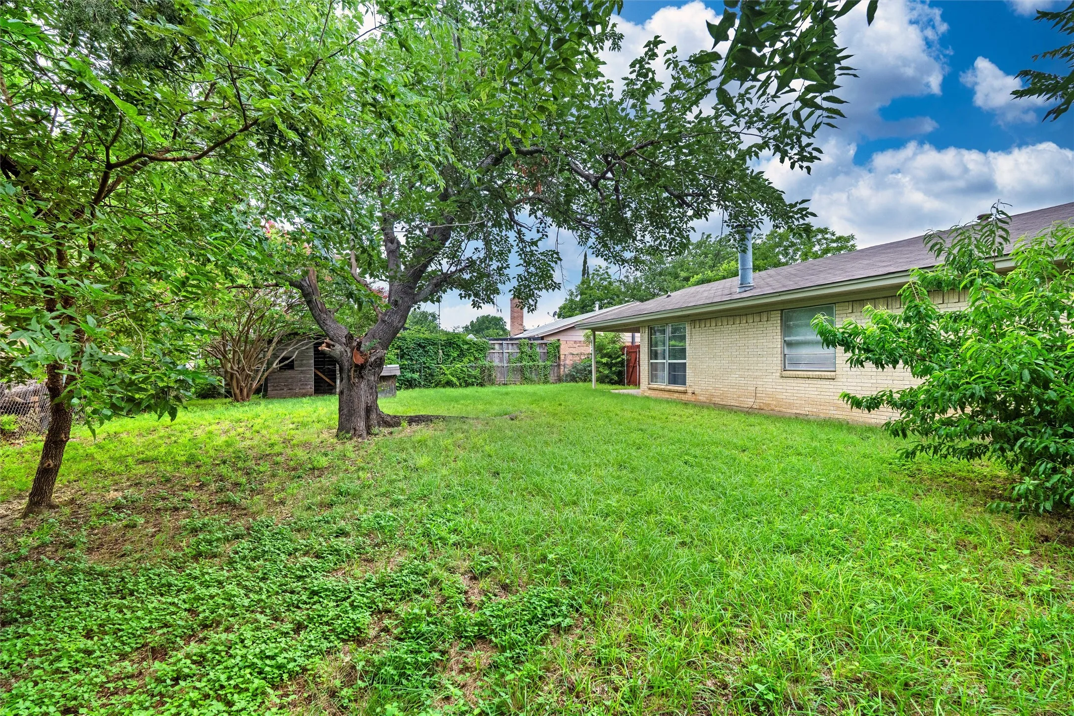 Step into a lush, tree-filled backyard with plenty of room to play, garden, entertain, or create the outdoor oasis you’ve always imagined.