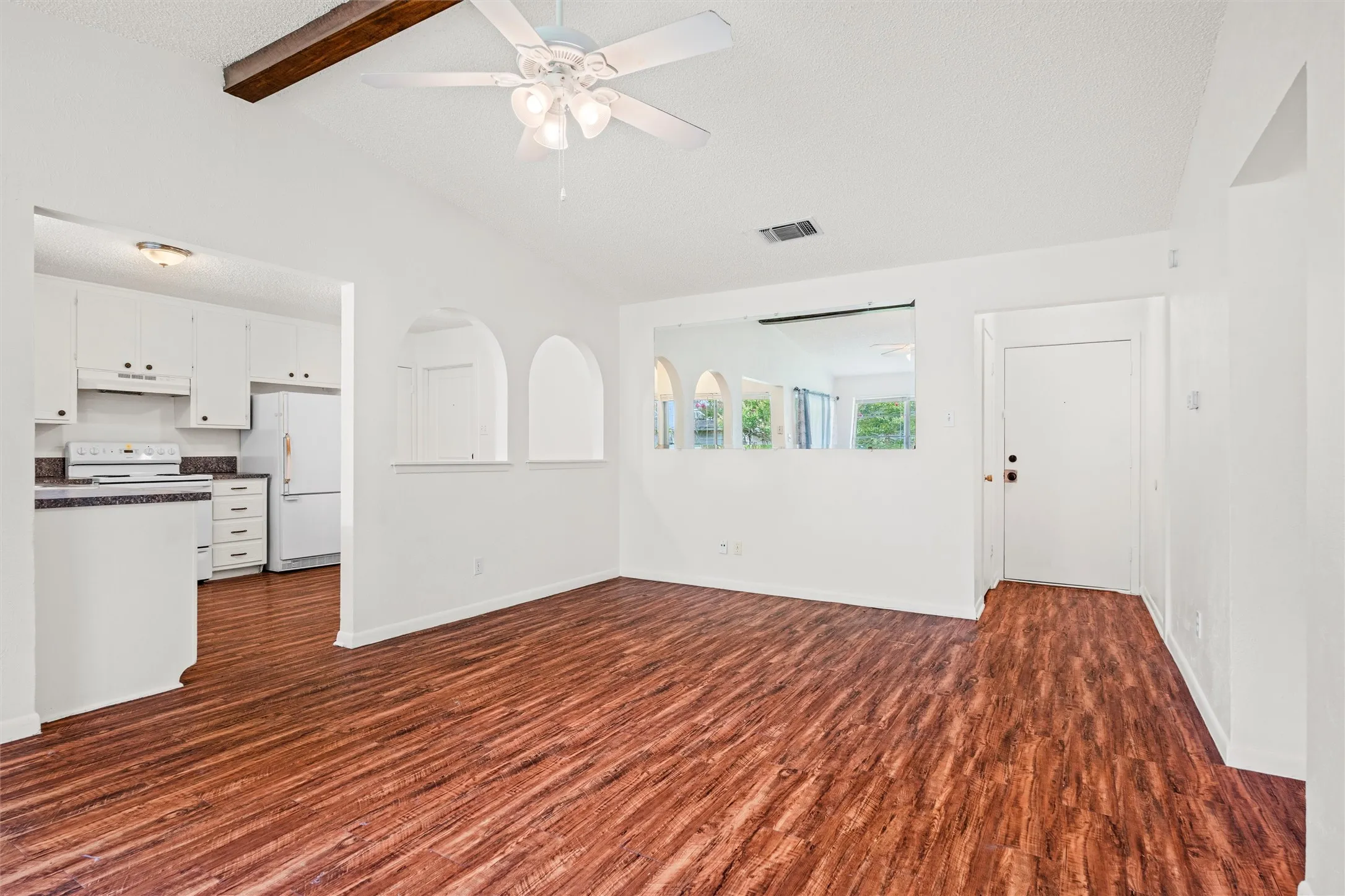 From the moment you enter, the open-concept design feels spacious and connected. Vaulted ceilings, rich flooring, and graceful architectural arches give this home a distinctive personality you won’t find everywhere.