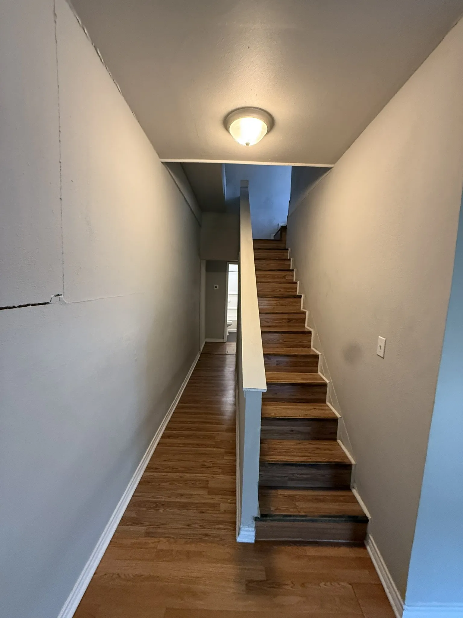 Hardwood stairs and wood-finish flooring define this entryway