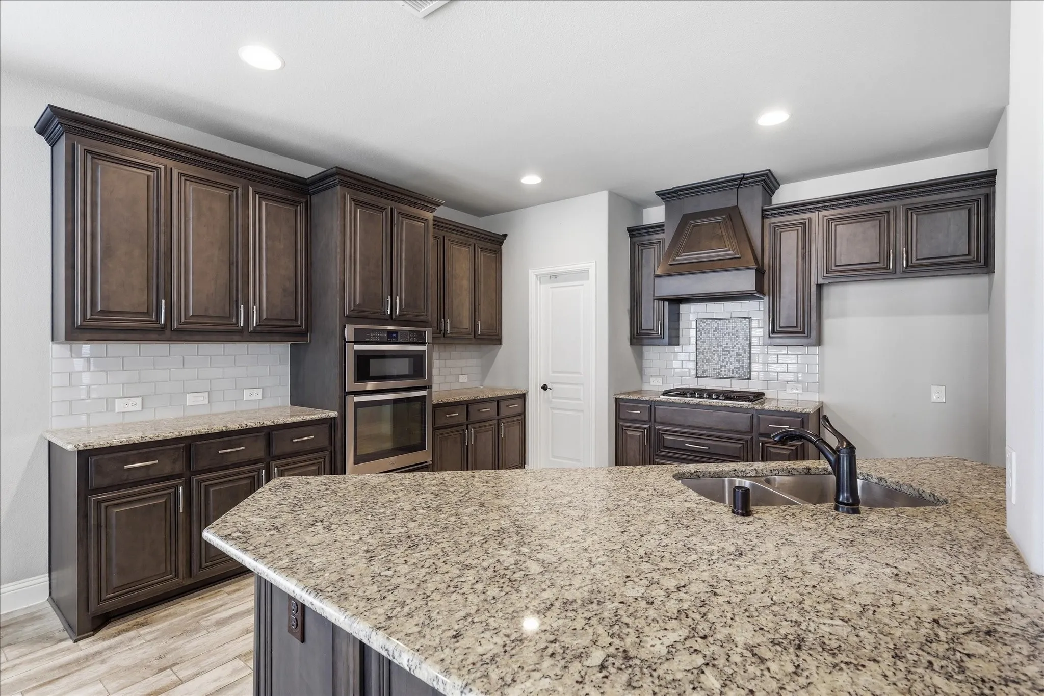 Granite counters, subway tile backsplash and gas cooktop with vent hood is a chef's delight.