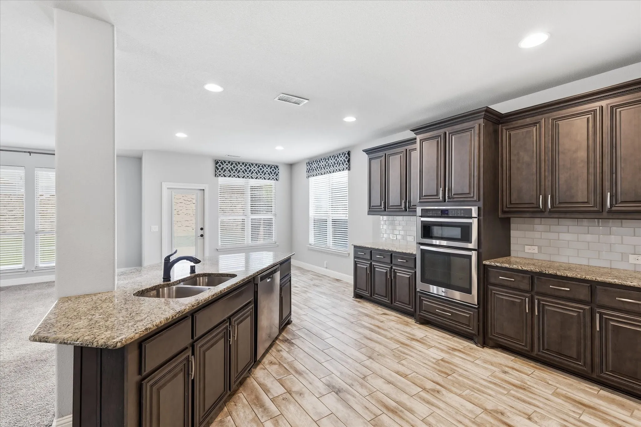 Large island anchors the kitchen with eat in dining area