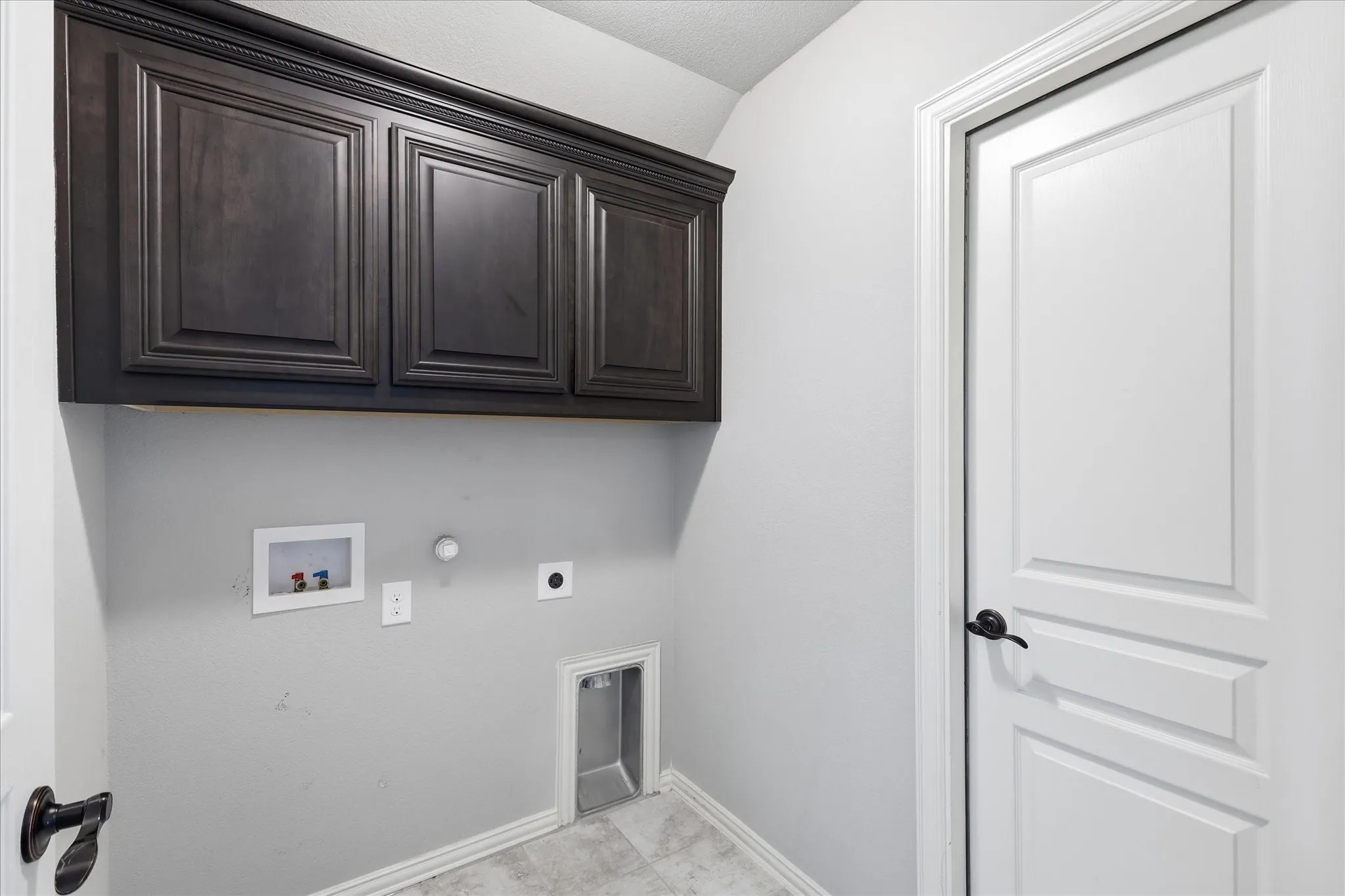 Laundry room is where all the action is - upstairs! Plus easy attic access.