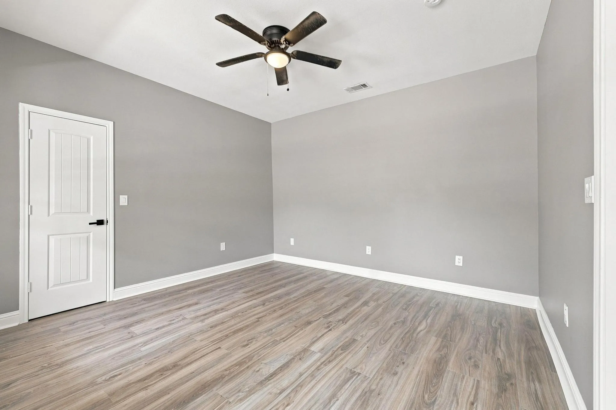 Neutral tone walls complement wood-finish flooring