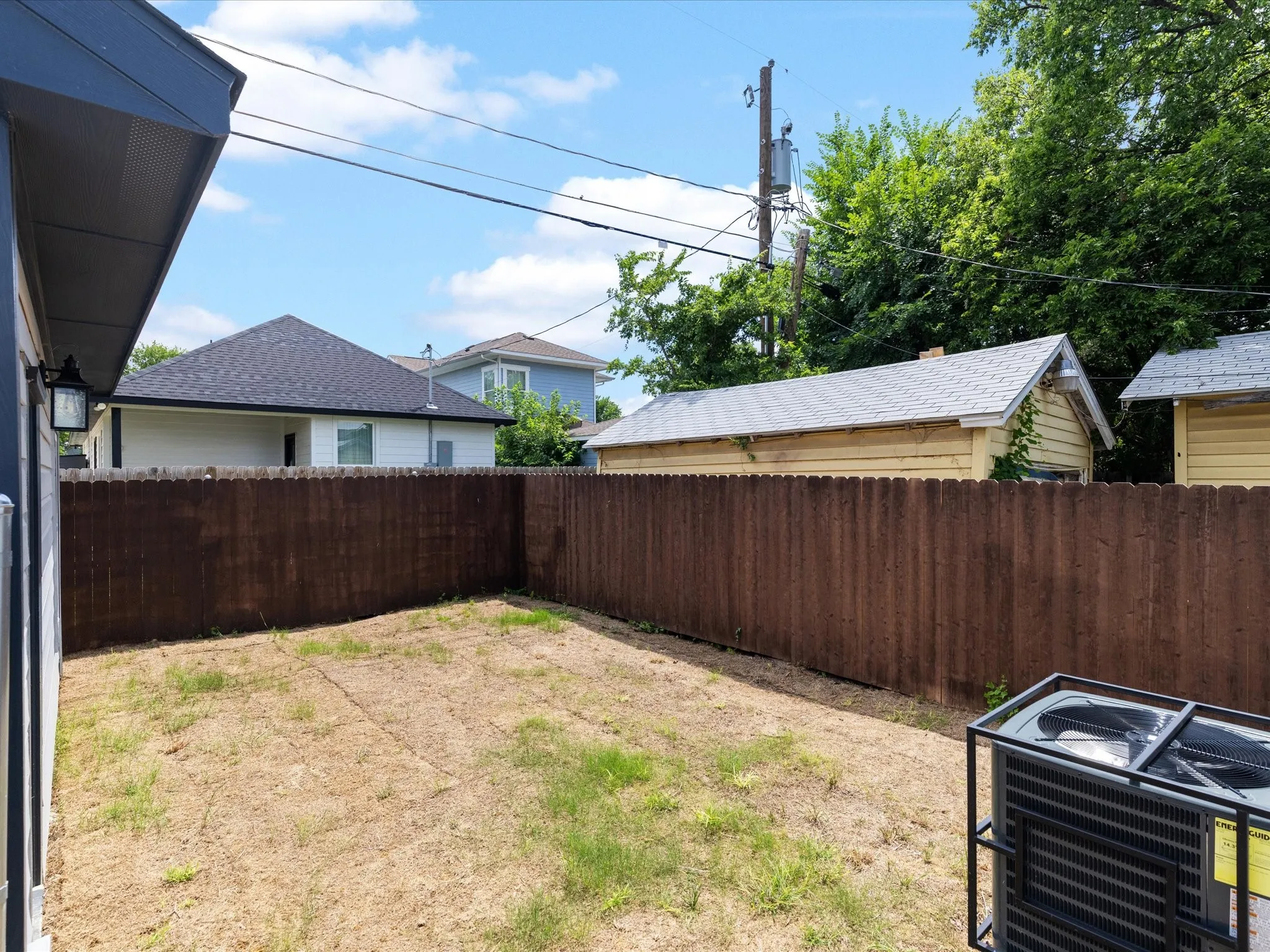 Enclosed backyard with wood privacy fencing
