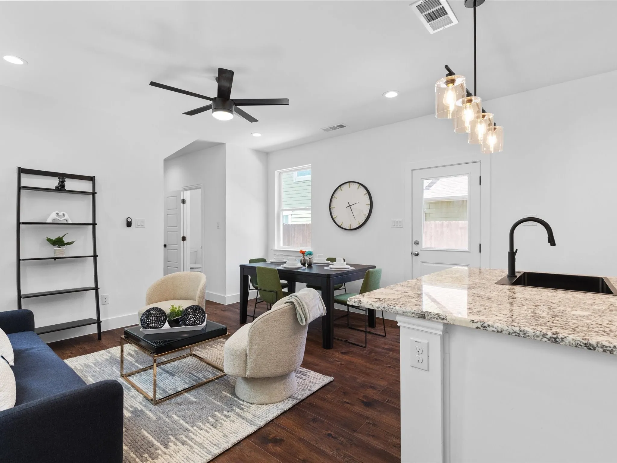 Open-concept living space featuring wood-finish flooring, recessed lighting, and a contemporary ceiling fan