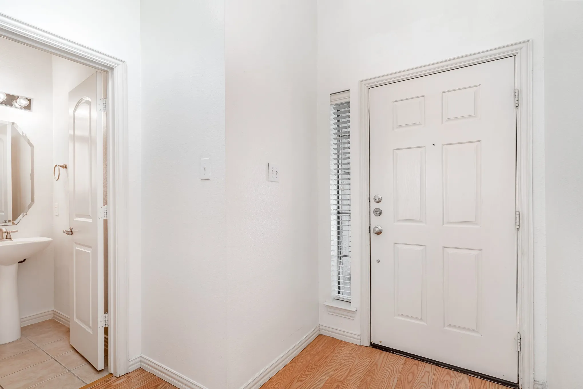 Foyer with light hardwood / wood-style flooring