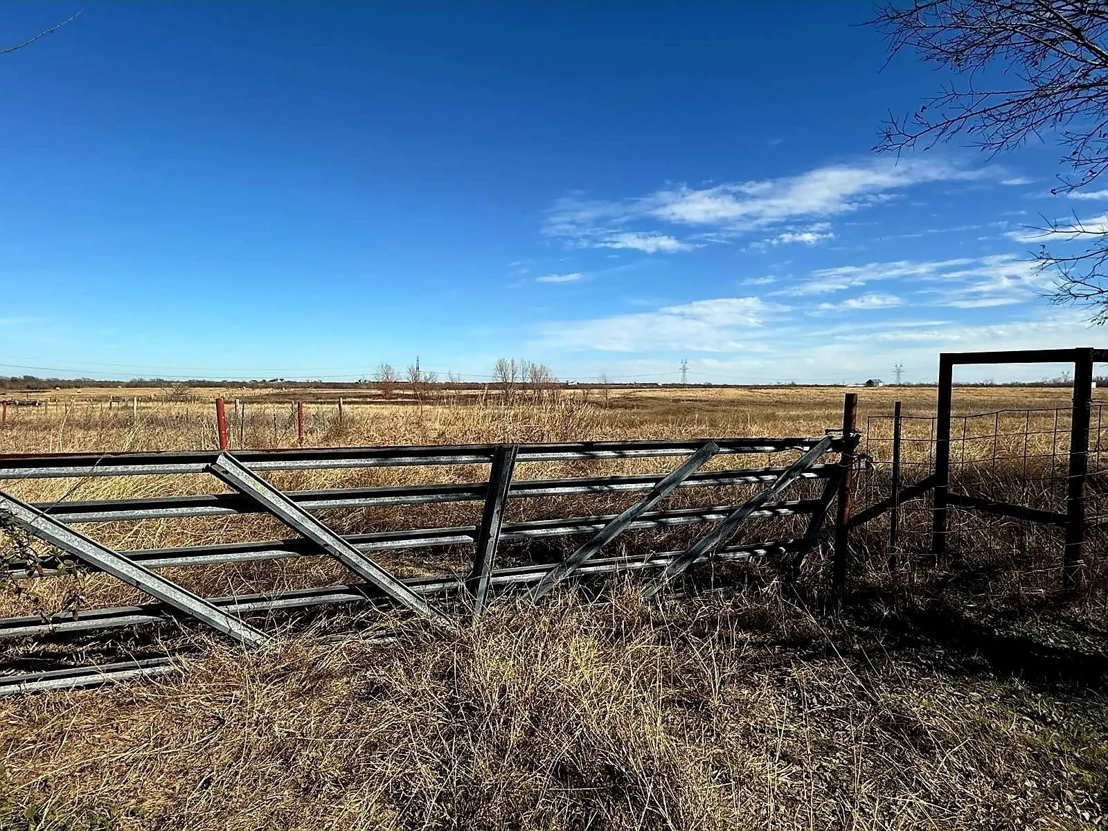 Expansive open acreage featuring a metal fence and gate entry