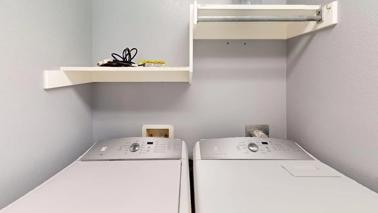 Dedicated laundry area featuring a light gray wall finish