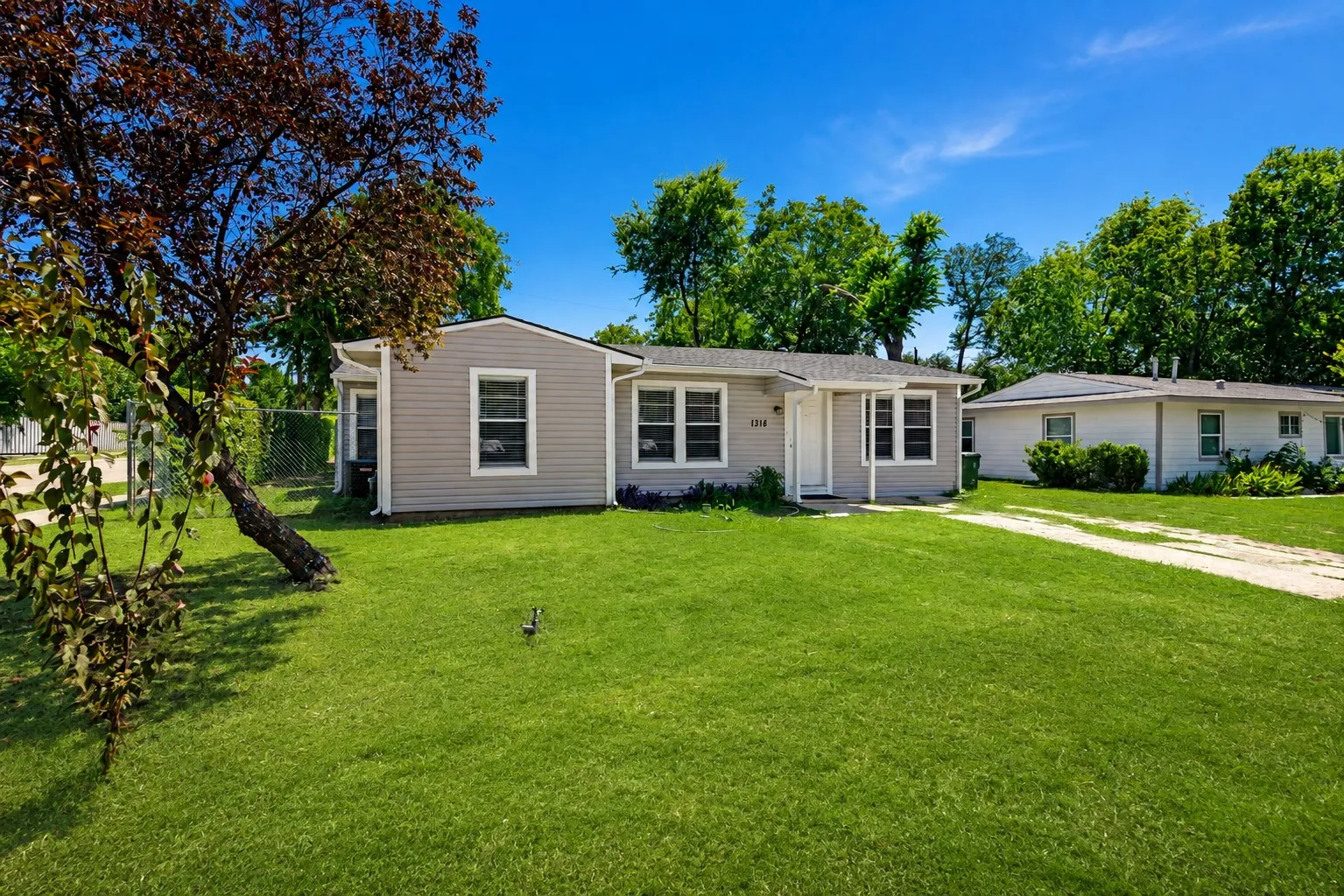 Single-story residence featuring light gray siding and white trim