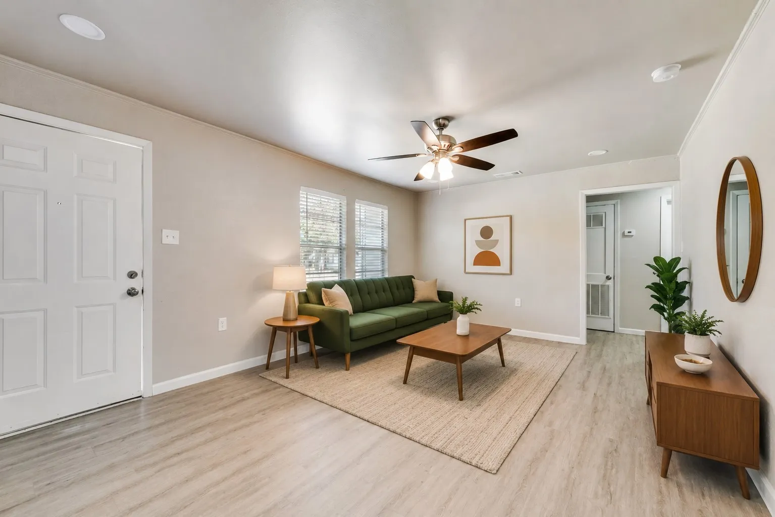 Light-toned wood-finish flooring extends throughout this room, complemented by neutral wall tones