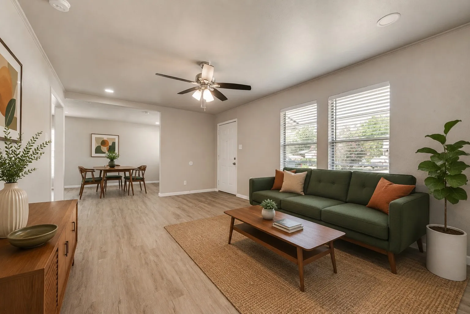 Open-concept living area featuring wood-finish flooring, recessed lighting, ceiling fan, and window blinds