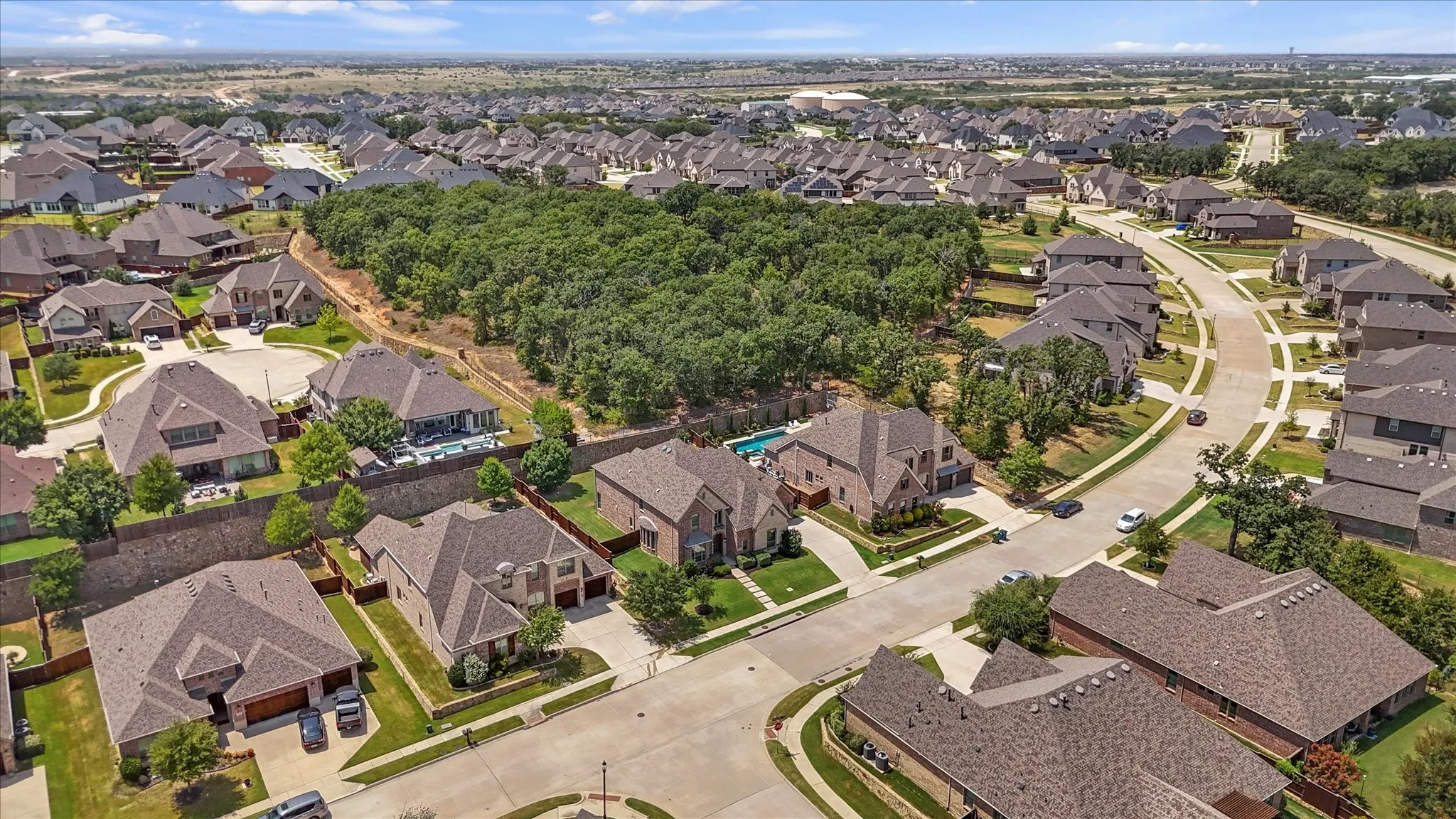 This yard is huge as the home sits on over a quarter acer lot! There is room here for endless ideas like a great pool and more. The stone wall and stained fence are in great condition. The yard is well maintained. The backyard backs up to a greenbelt for extra quiet and privacy.