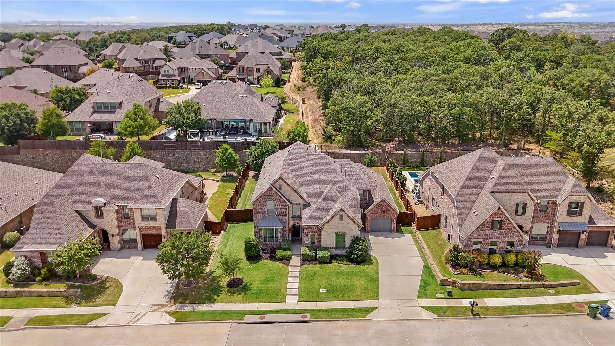 This gorgeous almost 5,000 sqft home features a 3 car garage, a gorgeous brick and stone elevation, over a quarter acre lot that backs up to a quiet greenbelt for extra privacy, and the perfect layout with two of the five bedrooms on the first floor, as well as a dedicated office!