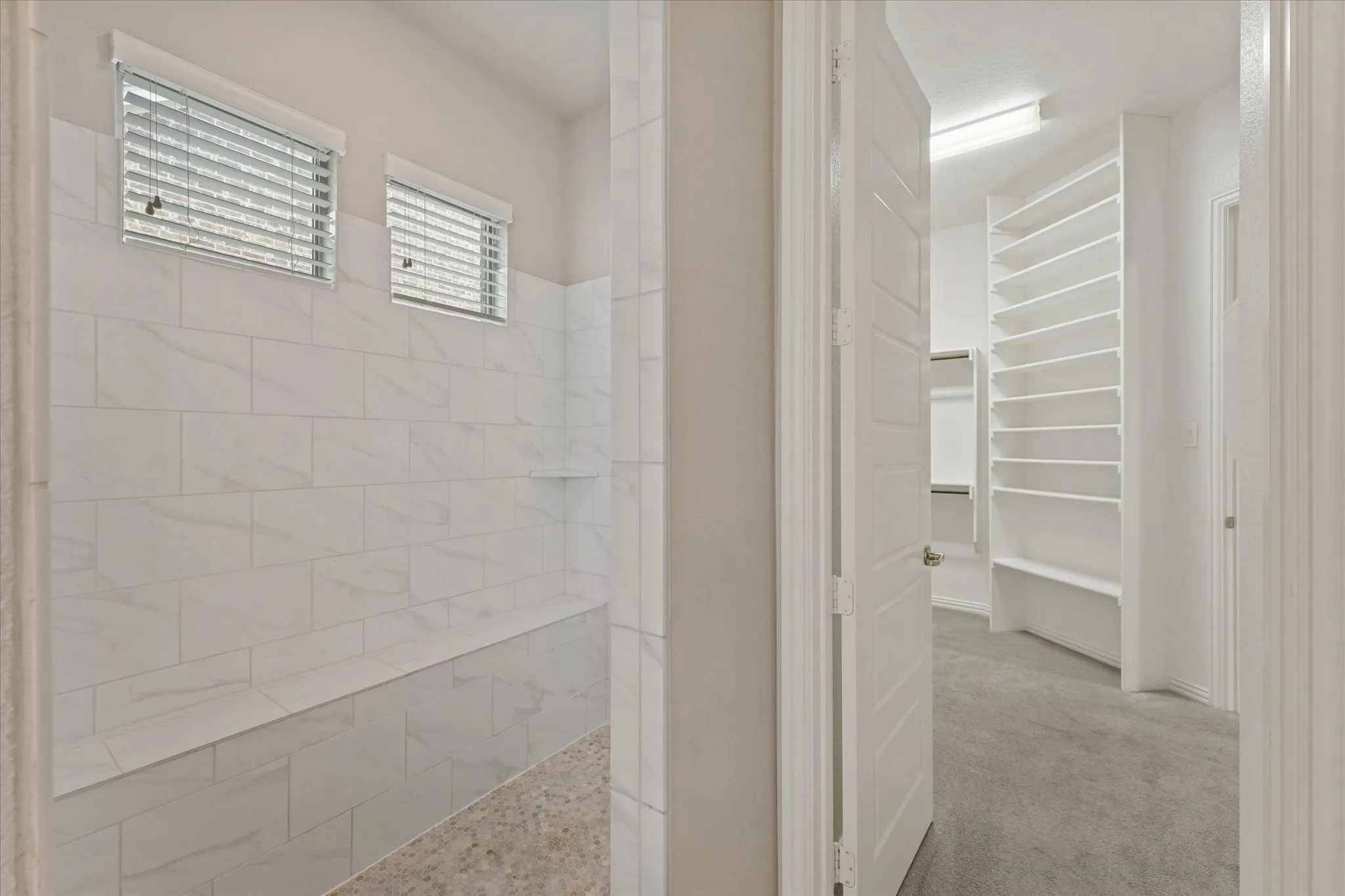 The primary bedroom is located on the first floor and has a perfect split floorplan with the other bedroom in the mother in law wing. Both feature an ensute bath. The main primary bath is huge! It features a nice tile walk in shower, a large garden soaking tub, and separte vanities as well as a gigantic walk in closet.