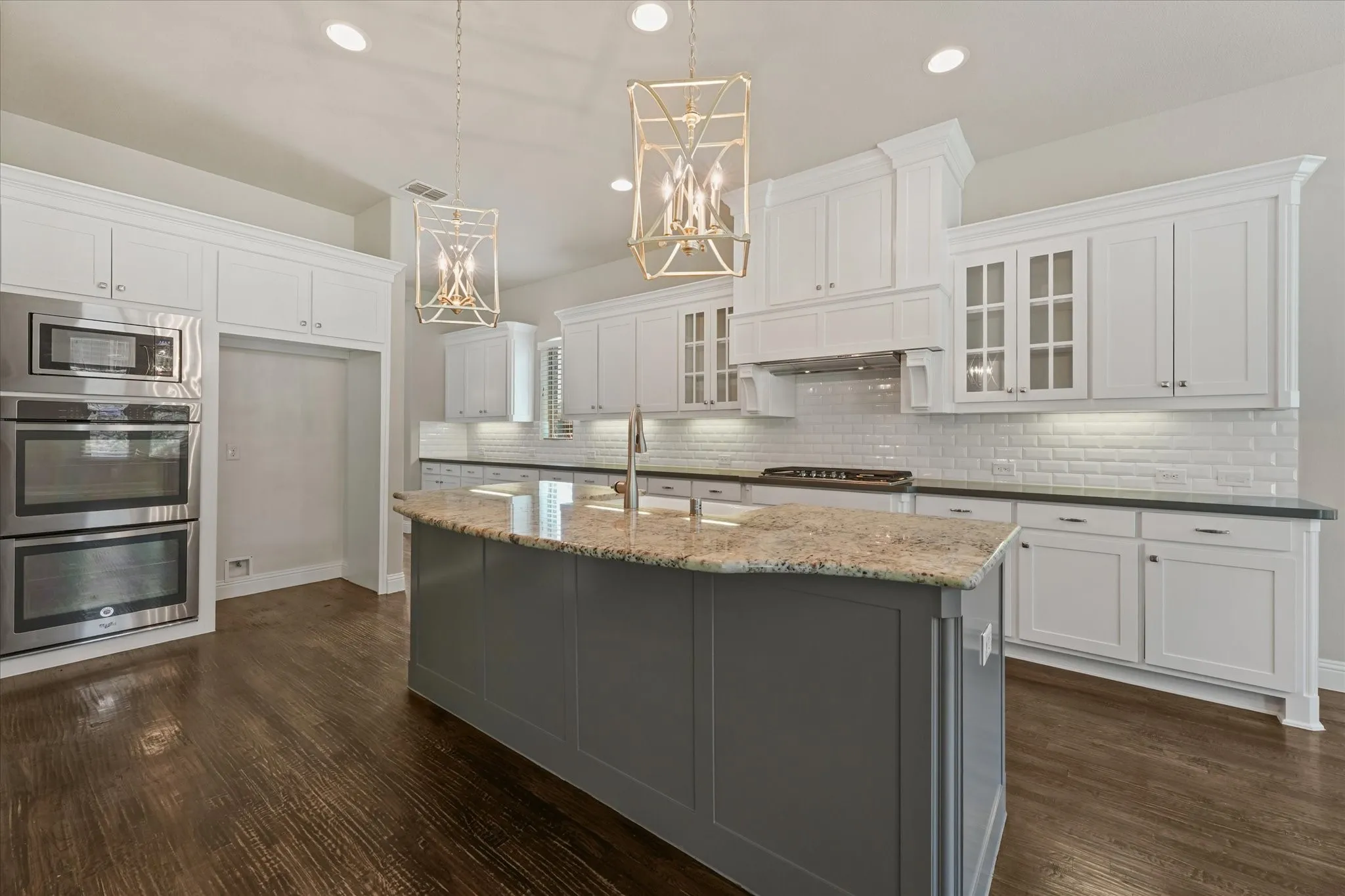 The home features fresh paint throughout on every surface of the 4,971 sq ft home! (walls, ceiling, doors, trim, baseboards, molding, cabinets, etc) It shines like new! This entire home has been refreshed with even new carpet on the upper level too! First floor showcases hand scraped hardwood floors. Kitchen features built in SS appliances, a gas cooktop, tons of storage, granite and quartz countertops, a deep farmhouse sink, gorgeous lighting fixtures, an island with room for barstools, eat in kitchen, open floor plan, and more!