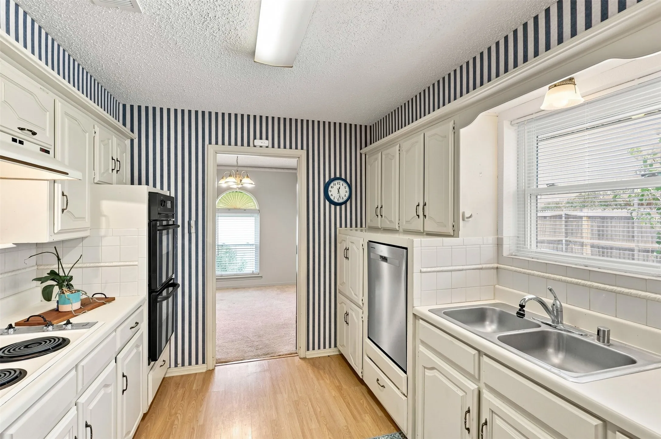 Galley kitchen with dual ovens, new dishwasher, and
