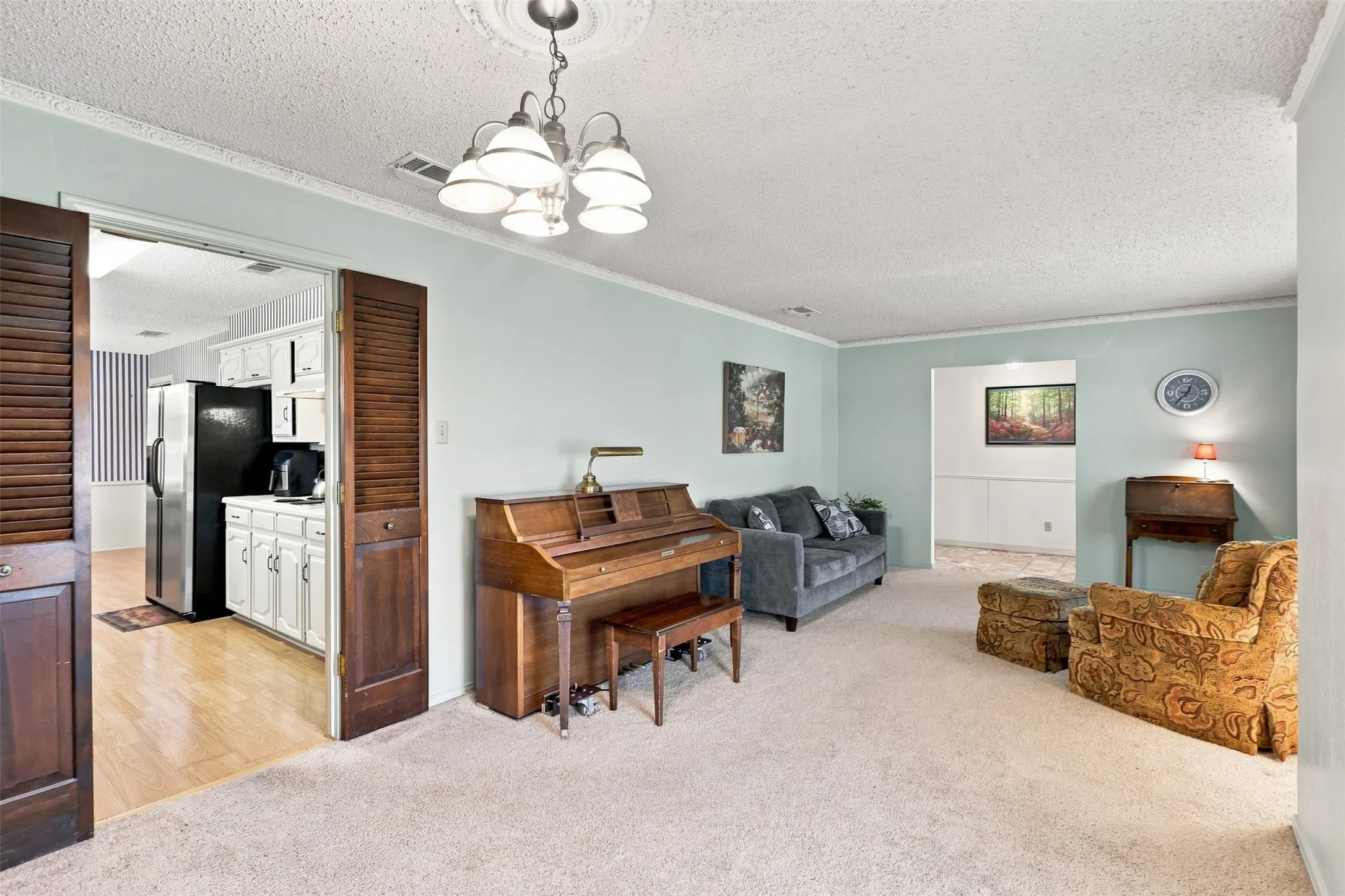 Formal living room located off the entryway that leads to the kitchen.