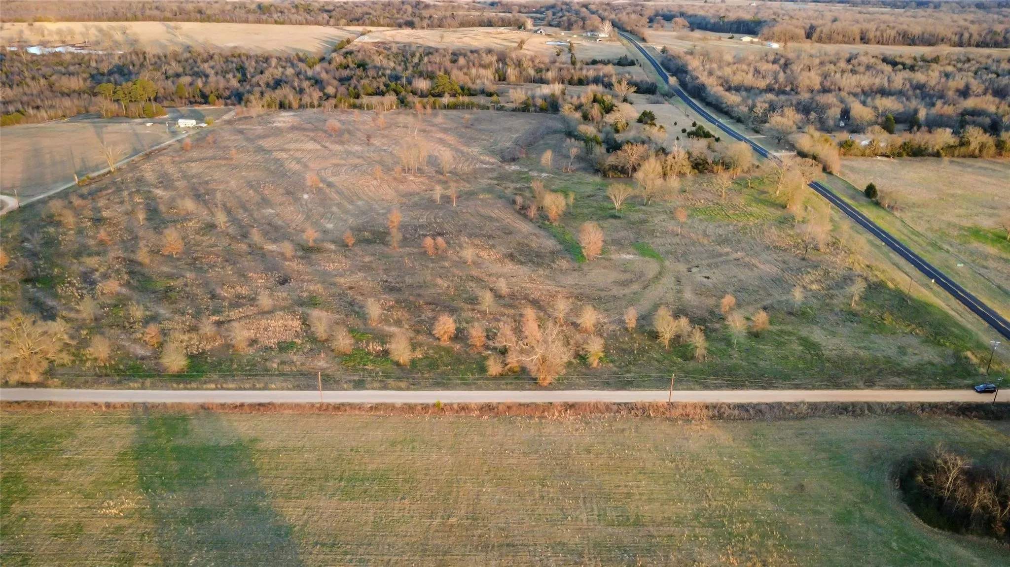 Expansive undeveloped land featuring mature trees and open fields