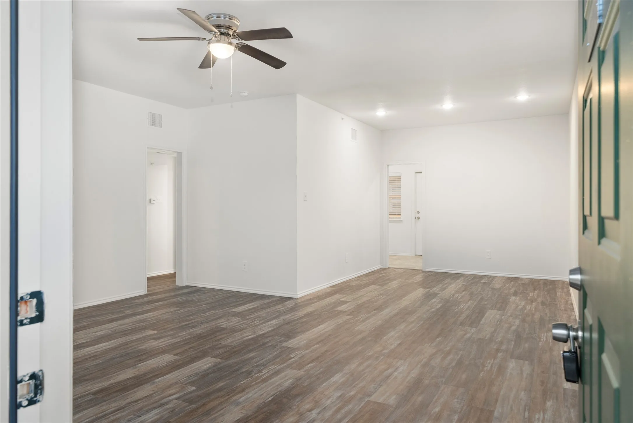 Open interior space featuring wood-finish flooring and neutral wall tones