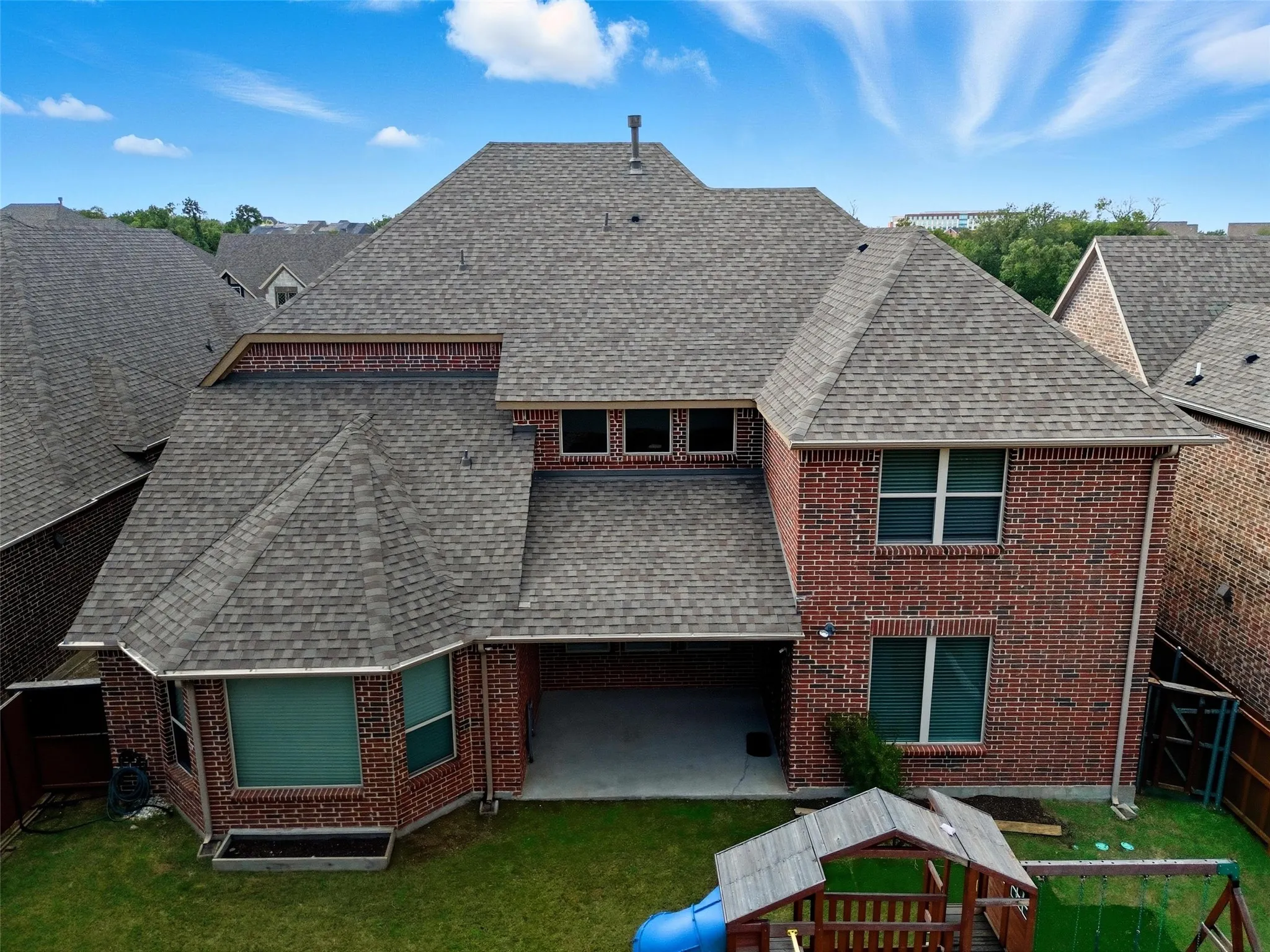 Red brick exterior featuring multiple windows